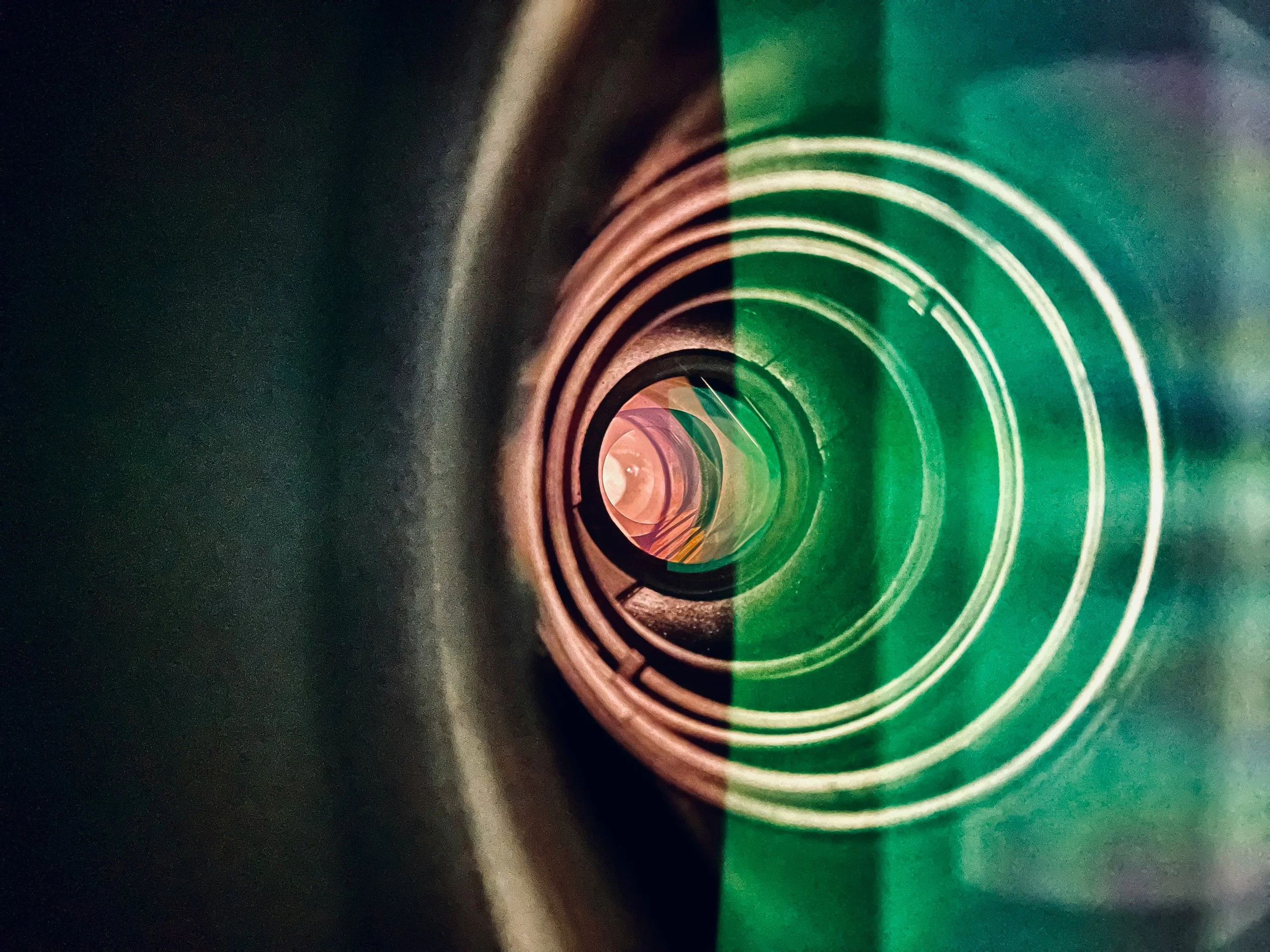 Close-up view of a green and pink colored spiral tunnel.