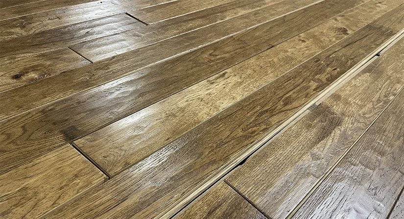 Close-up of a polished hardwood floor with visible wood grain and seams.