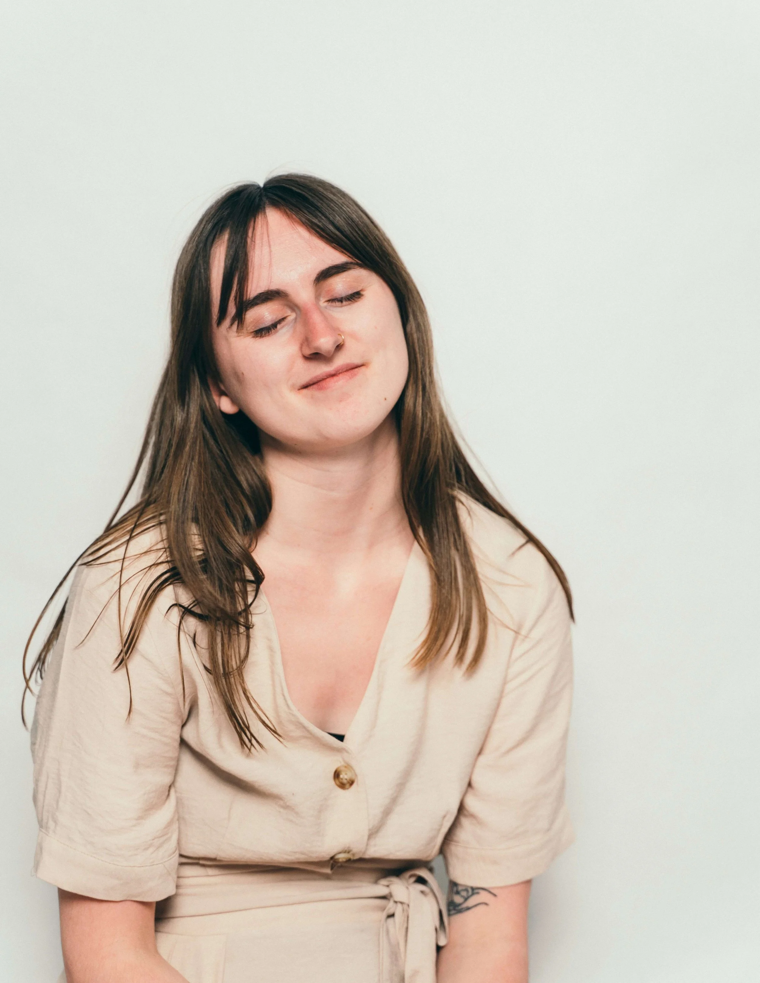 Person with eyes closed and calm expression in soft light — representing the gentle, low-distress experience of FLASH therapy