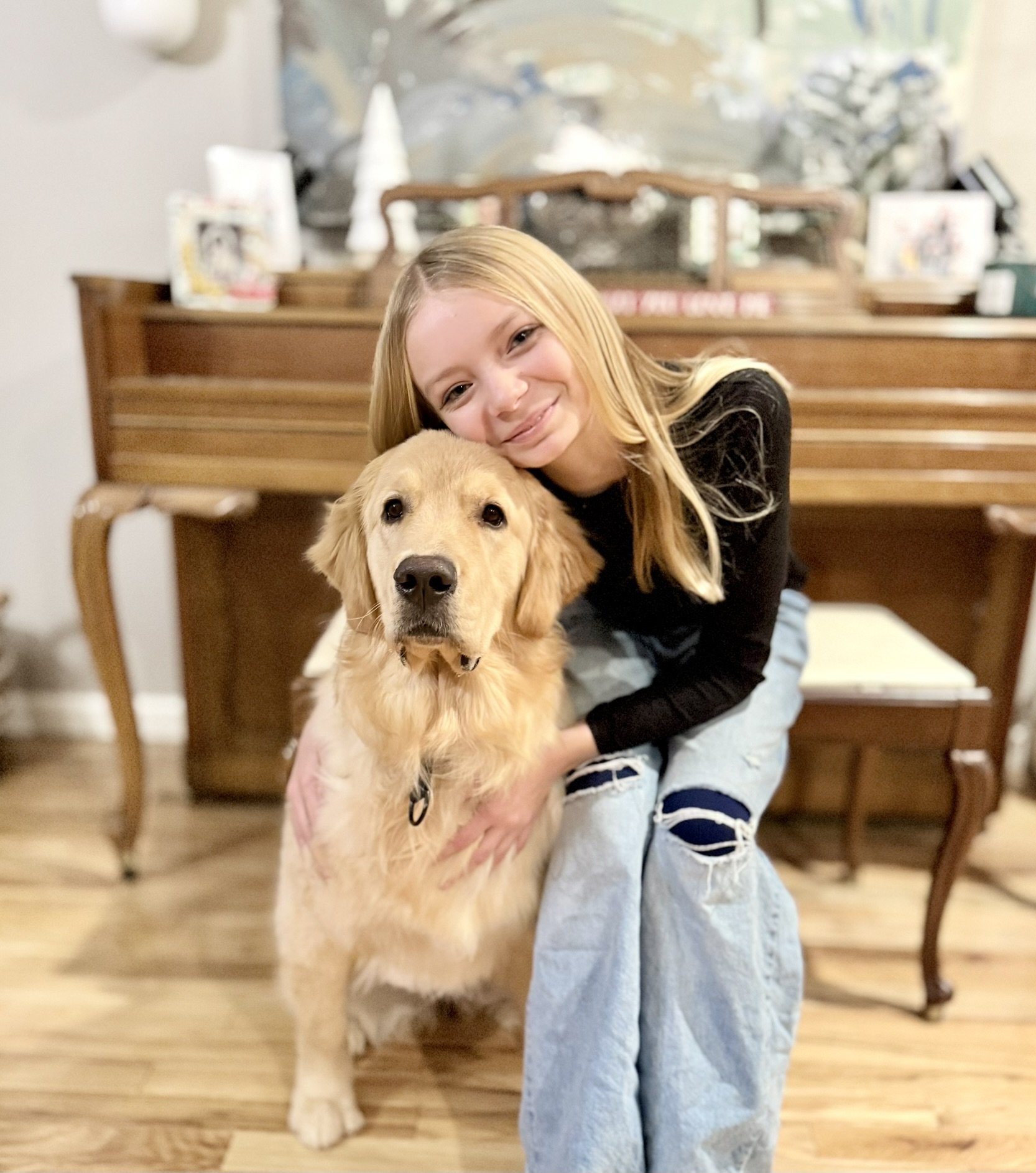 Girl inventor of EZ-Grab Collar and her golden retreiver puppy who inspired the product.