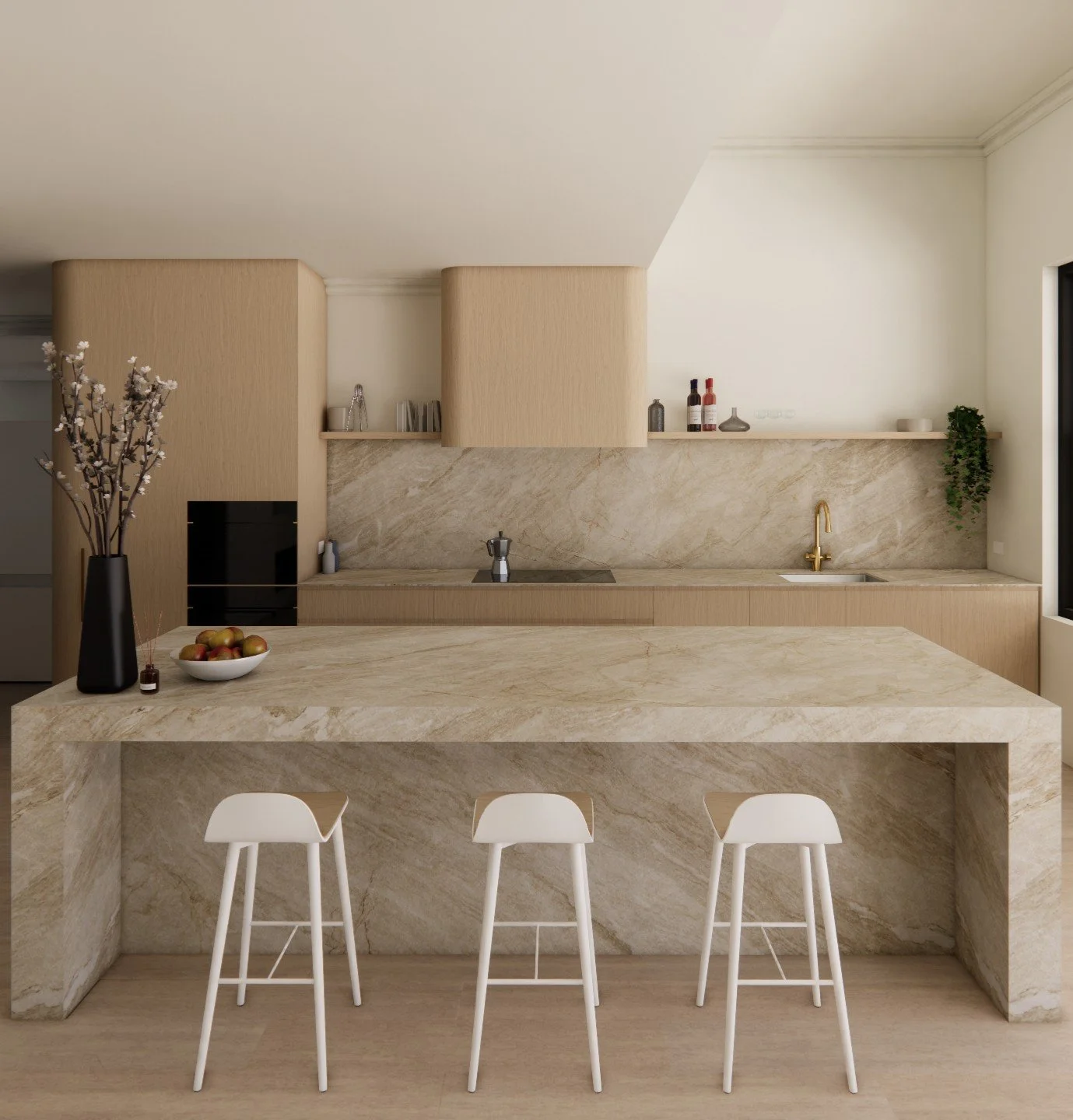 Modern kitchen with a marble island, white chairs, beige cabinetry, small black stove, and decorative items including a bowl of apples on the island.