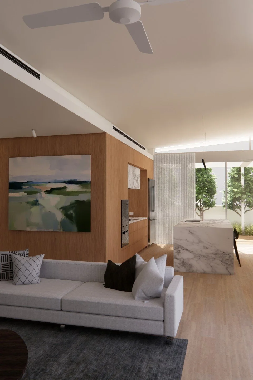 Modern living room with white sofa, black and white pillows, wooden accent wall with landscape painting, marble island, trees visible through large windows, neutral color palette.