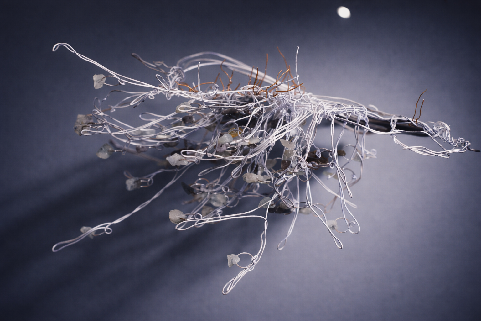 Where the Lake Was (detail), 2025 - ongoing, copper wire, aluminium wire, stone, light, variable dimensions