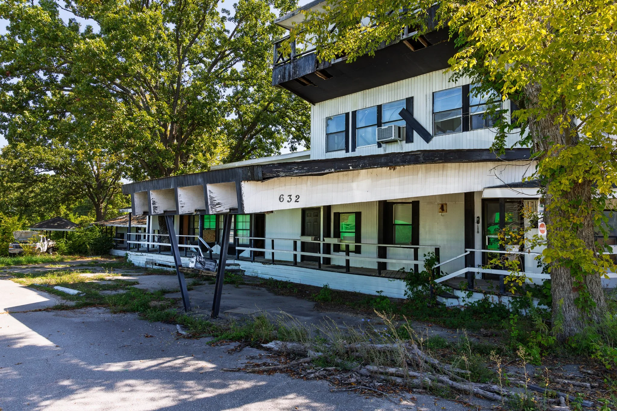 Vacant Alpine Haus Motel balcony with broken windows.