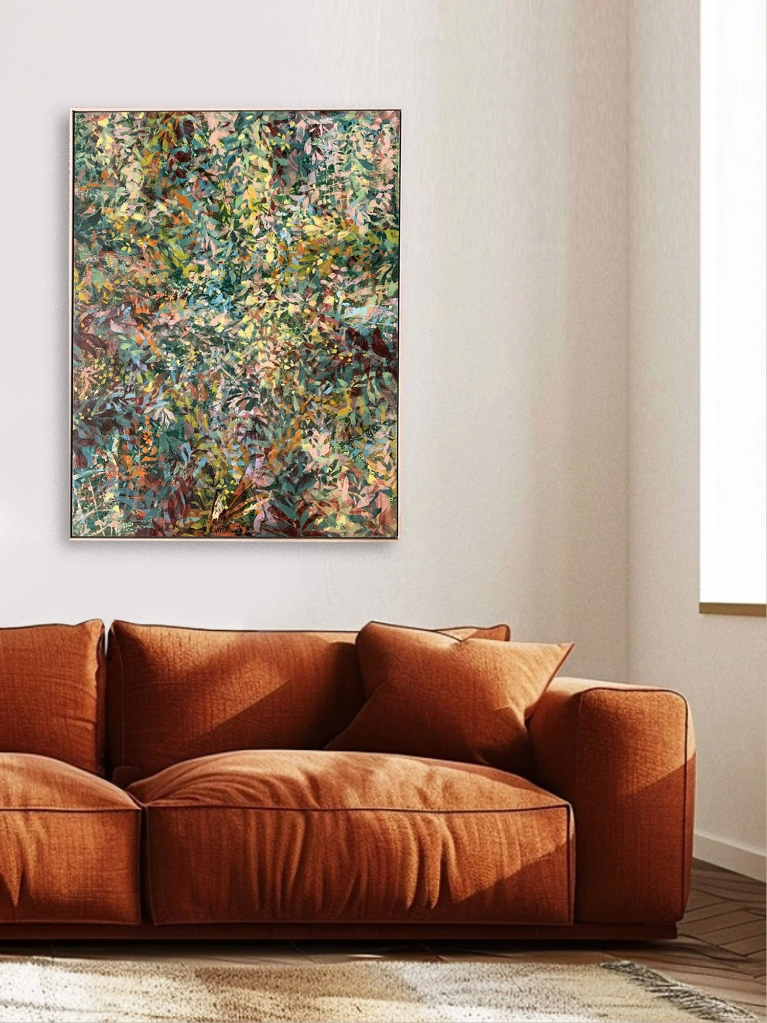 Interior of a living room with a rust-colored sofa and a colorful, abstract painting on the wall behind it. There is a window on the right side of the image.