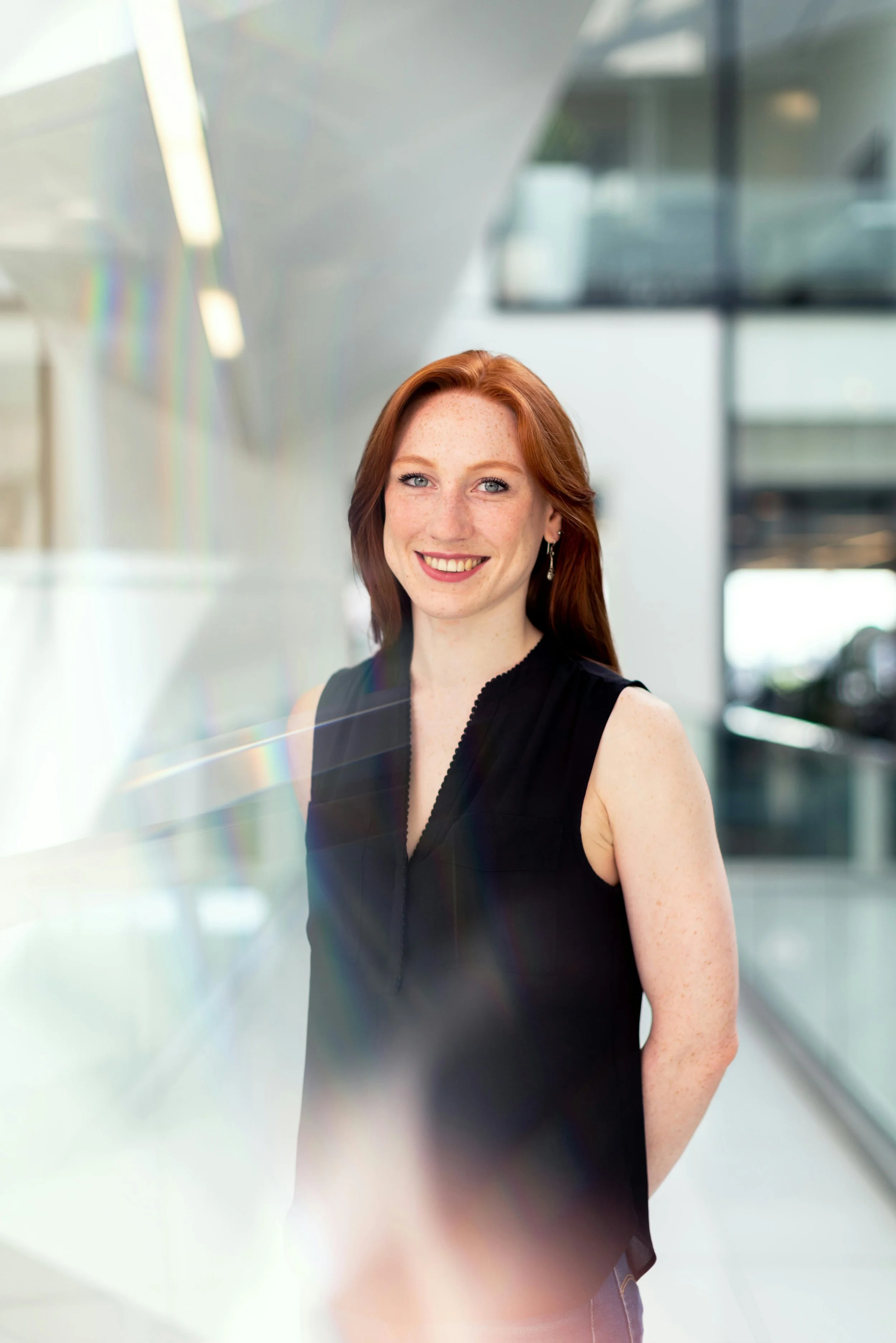 Young woman standing proud at her workplace as an evolving leader