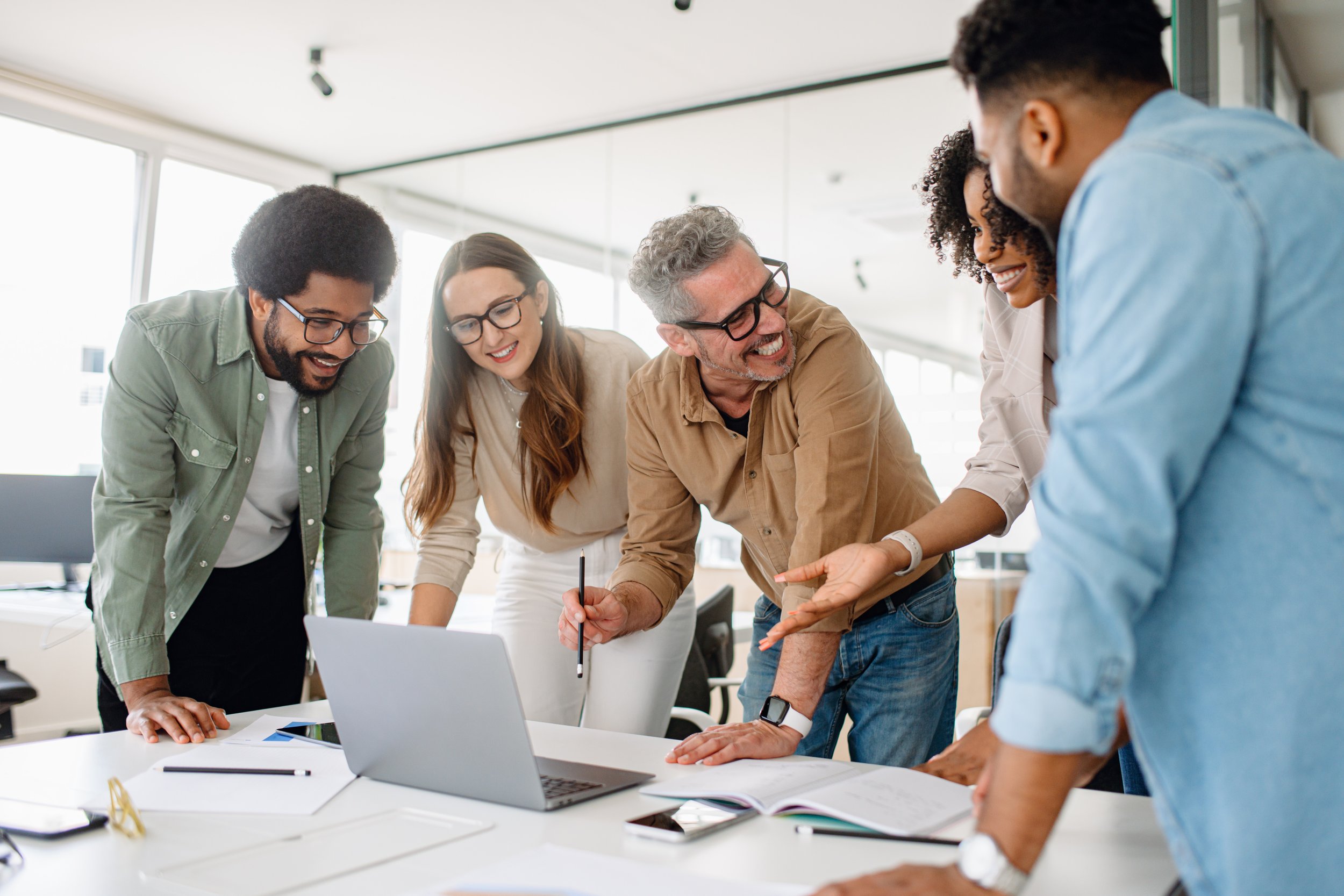Group of happy coworkers in a state of wellbeing during a supported workplace experience