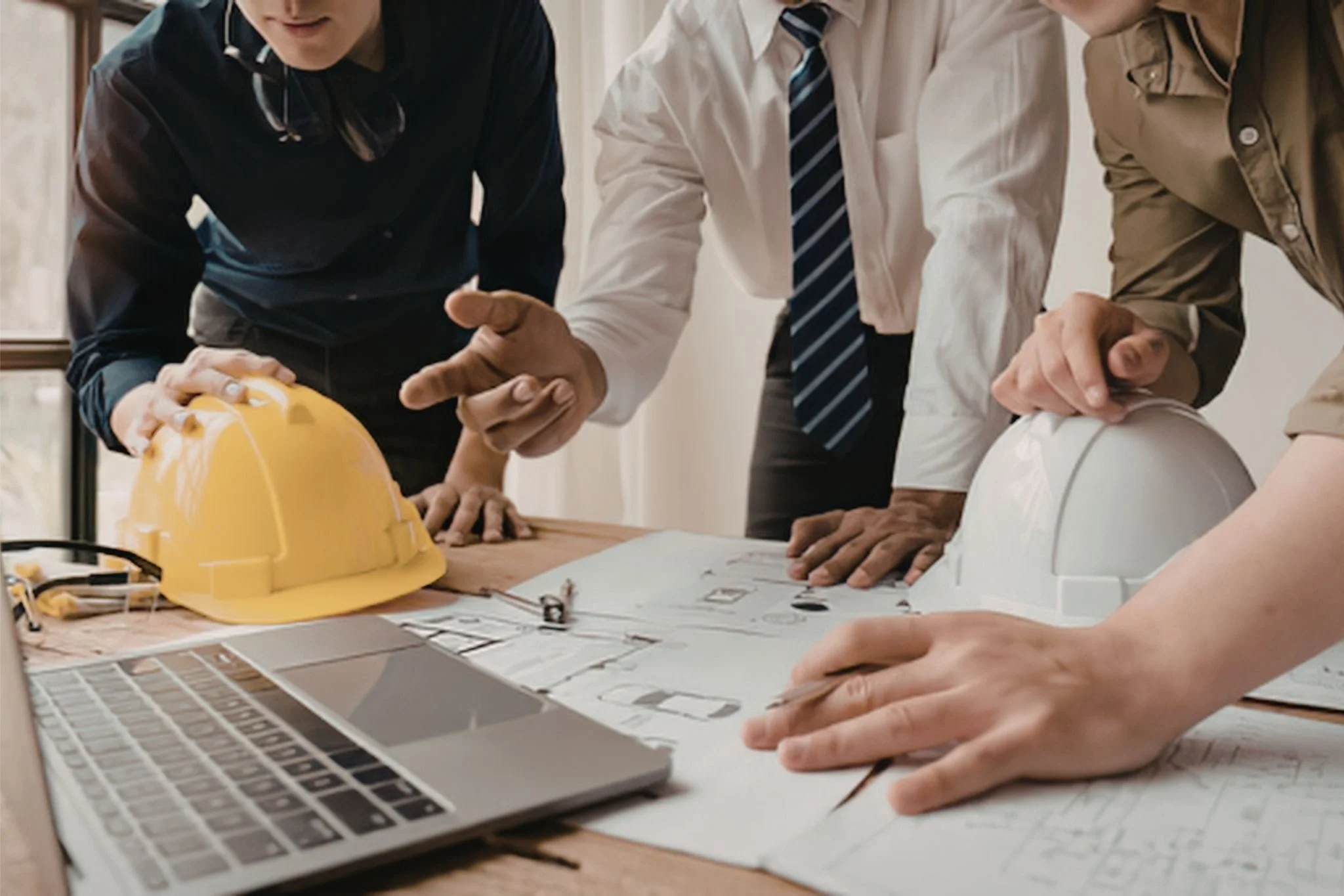 Contractor reviewing job cost tracking with calculator and paperwork, analyzing progress billing, WIP, and construction job profitability.