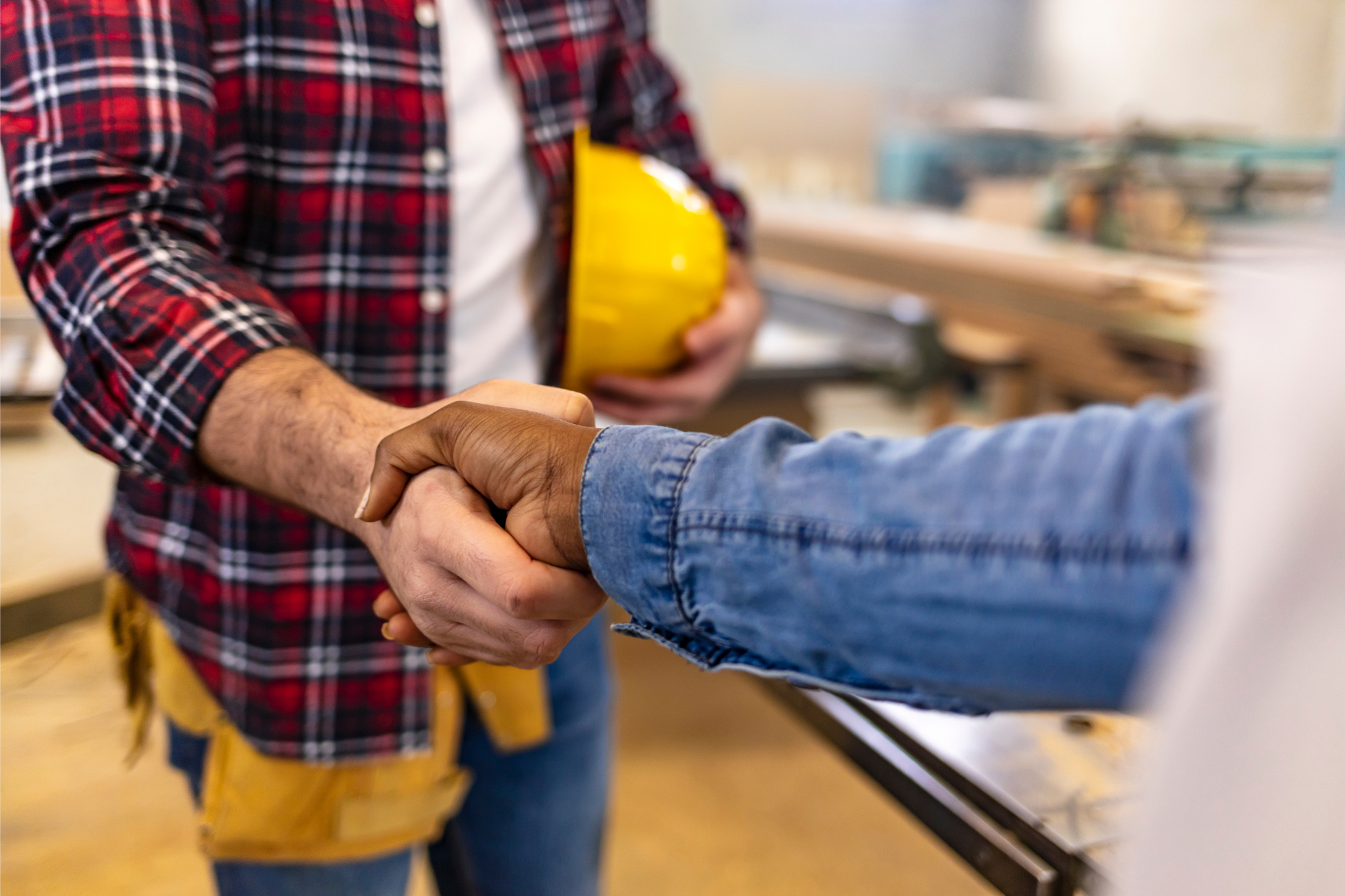 Contractor shaking hands on a job site agreement, representing construction business revenue, break-even point calculation, overhead costs, and profit planning to ensure projects cover expenses and generate profit