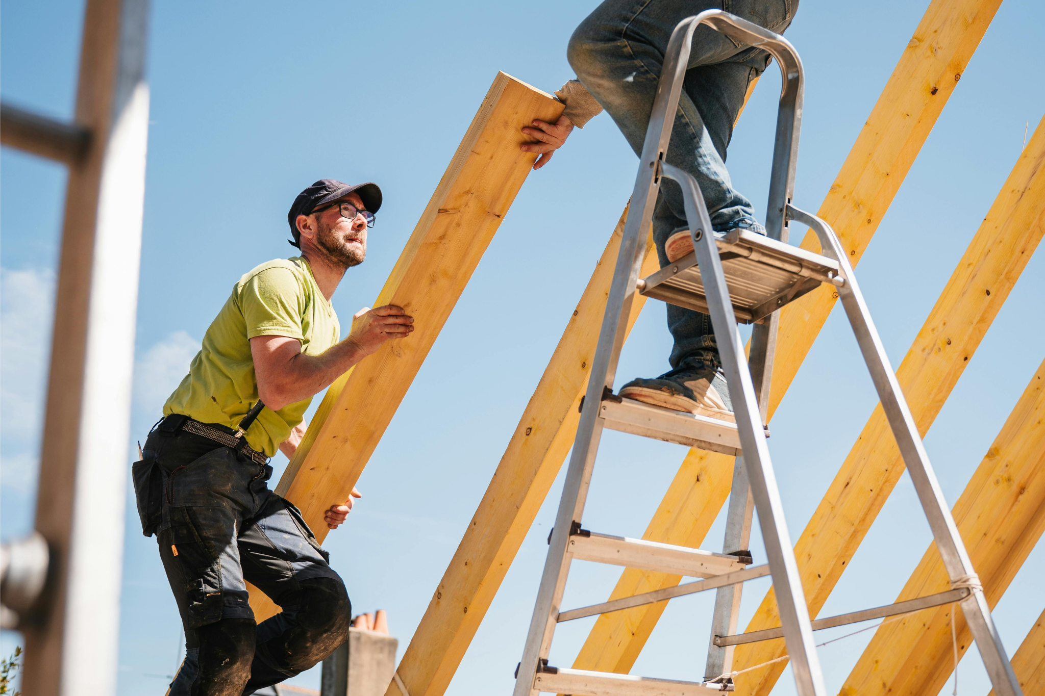 Construction workers on an active job site reviewing progress and materials, representing how project costs can become locked in, leaving limited ability to recover lost margin due to labor overruns, missed change orders, and delayed cost tracking.