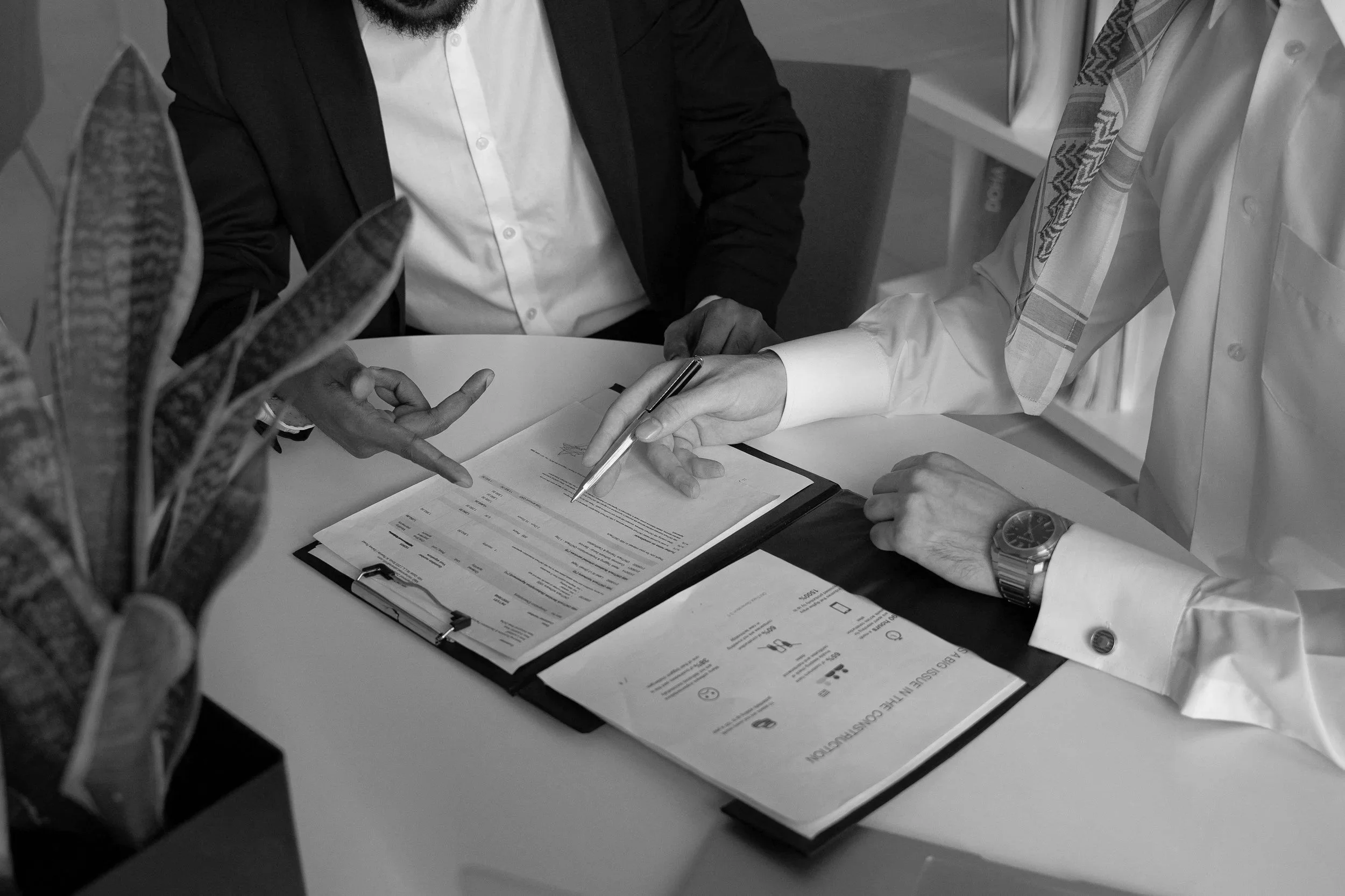 Reviewing job cost reports and financial documents in a meeting