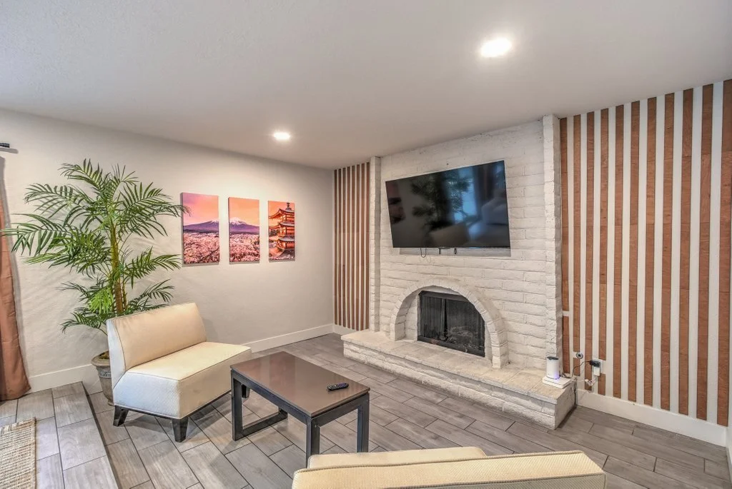 Furnished living room with a fireplace and television at a Las Vegas mid-term rental
