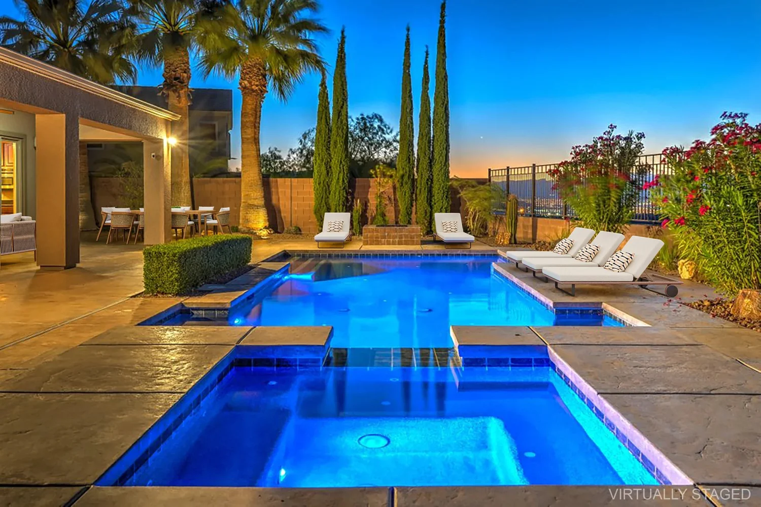 Las Vegas home with a lit pool at dusk