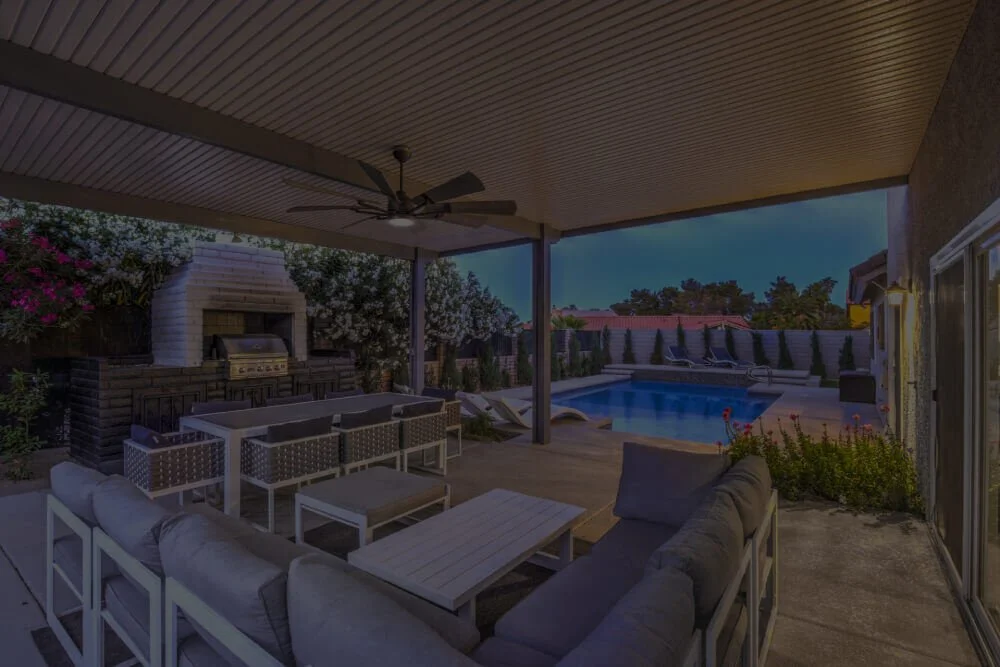 Covered patio and pool at a Las Vegas rental home in the evening
