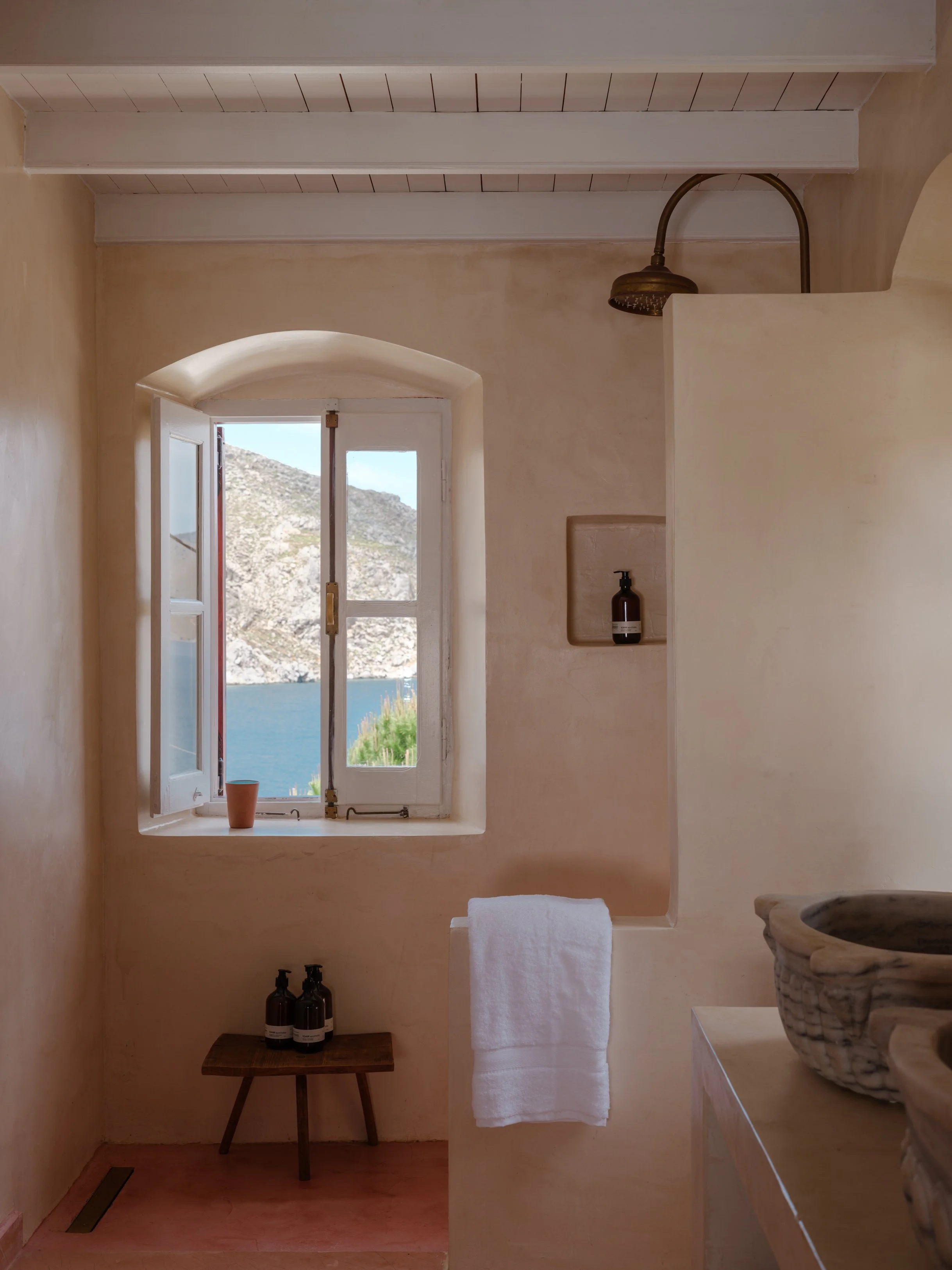 Selini suite bathroom with sea view shower and double marble sinks at The Selene Greece, Symi