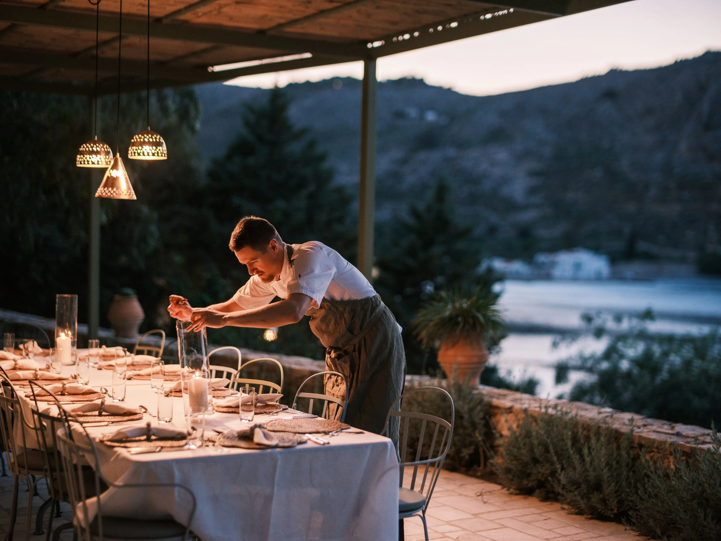 Eveing dining on the terrace with nimborio bay backdrop at the selene greece in symi