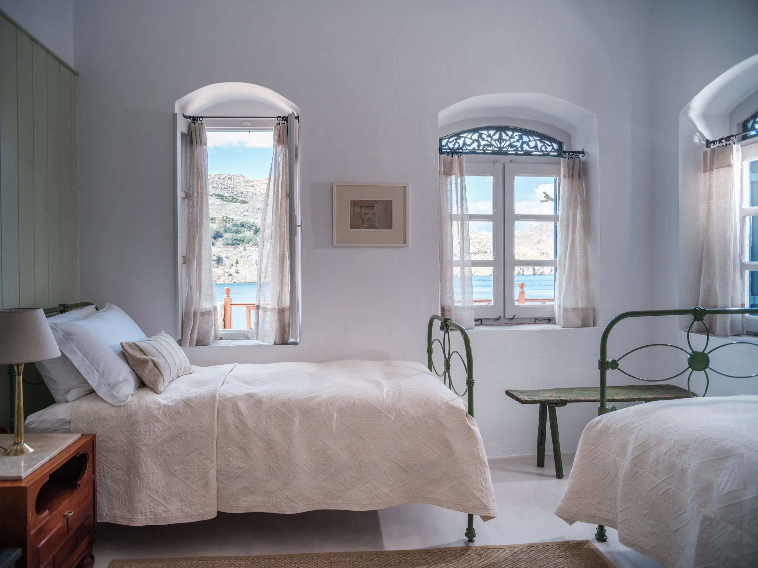 Thalassa suite bedroom 2 iron bed window with sea view at The Selene Greece, Symi