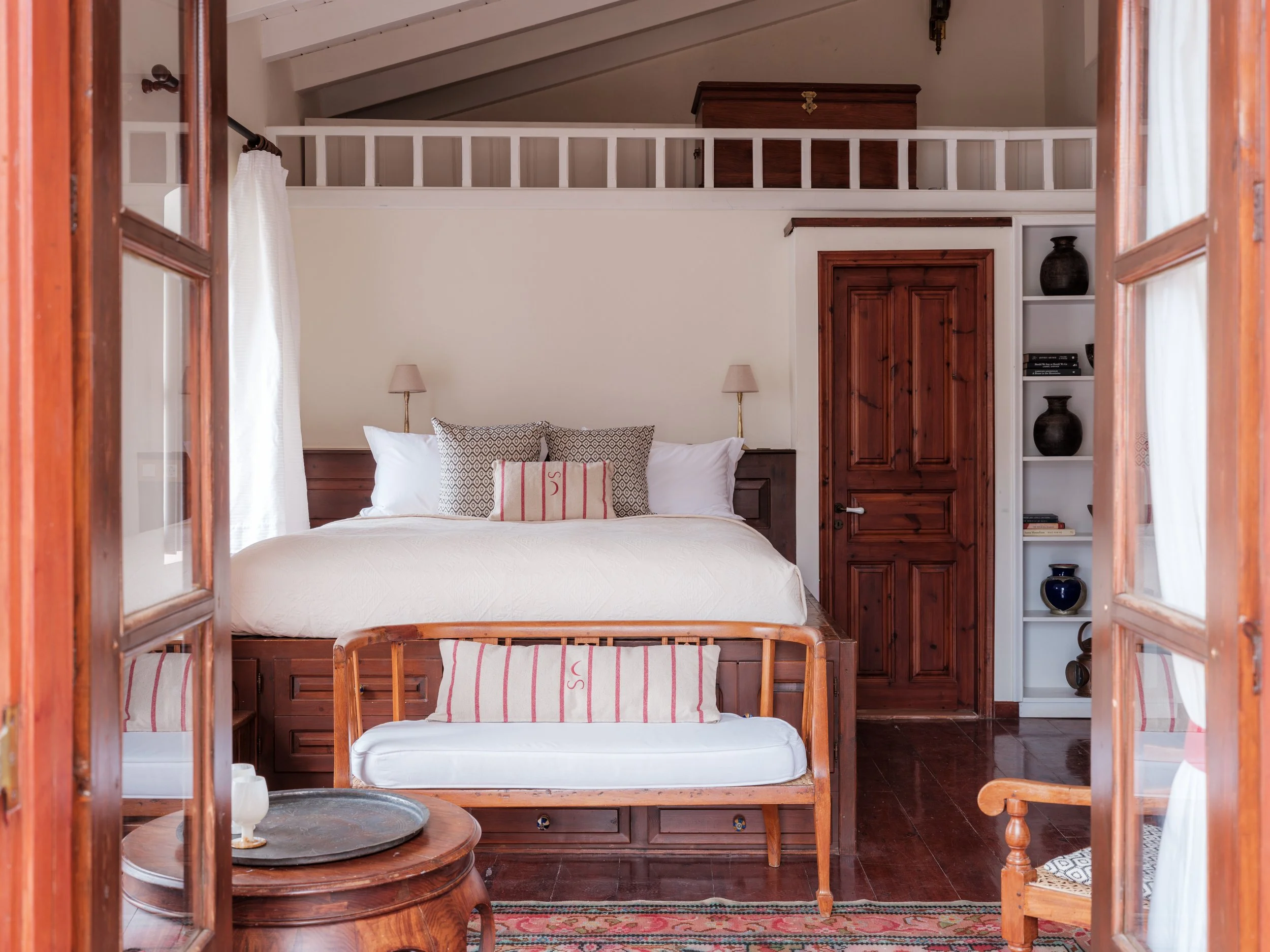 Selini suite bedroom at The Selene Greece, Symi, with balcony, terrace and sea view