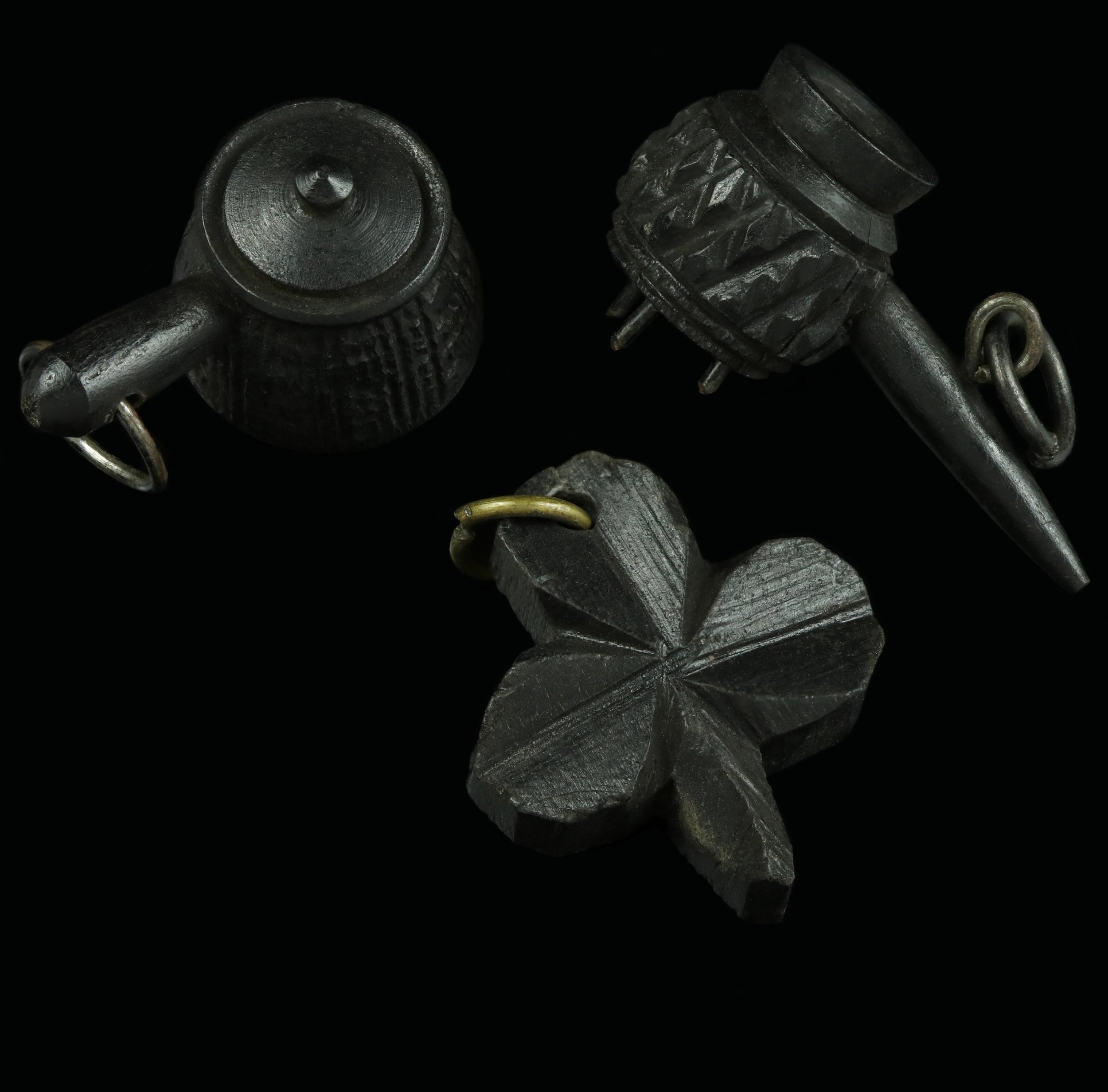 Three late Victorian wooden charms