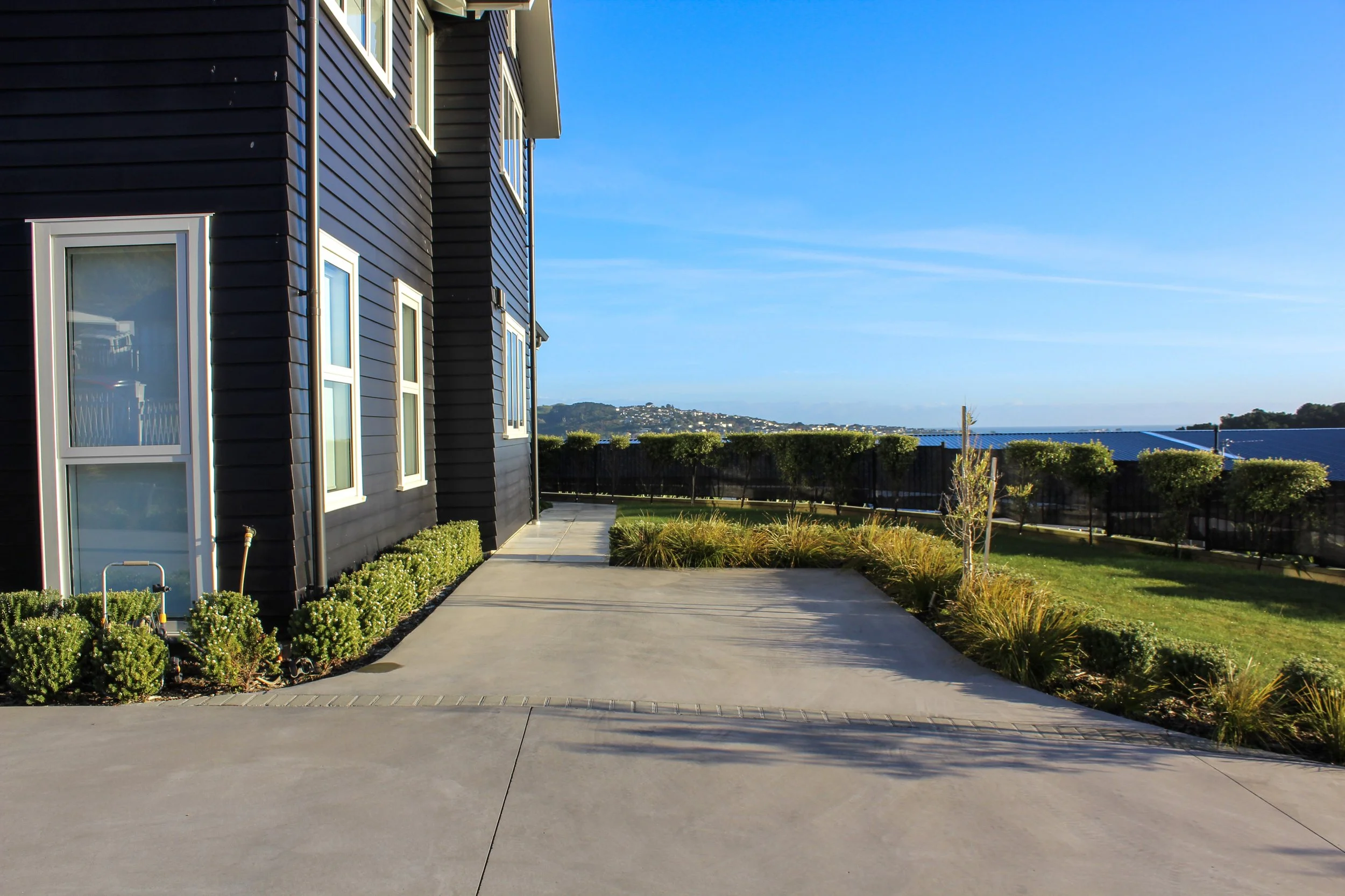 Structure around the driveway turn-around space provides a formal entry and exit to the home.