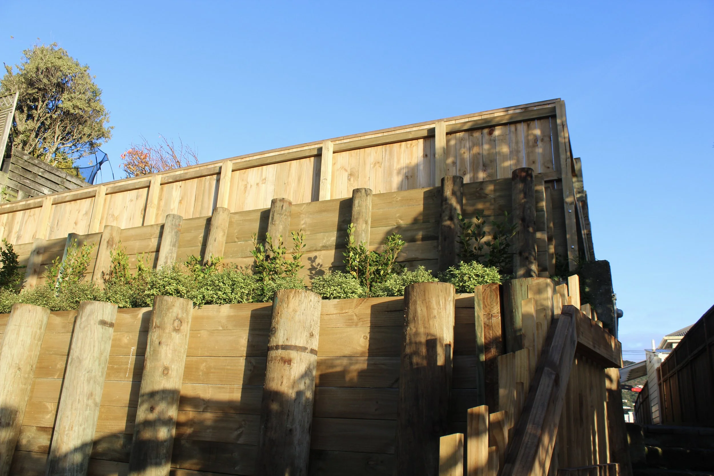 Upwards view of the retaining walls, highlighting the greenery in between to slowly hide the walls from view.