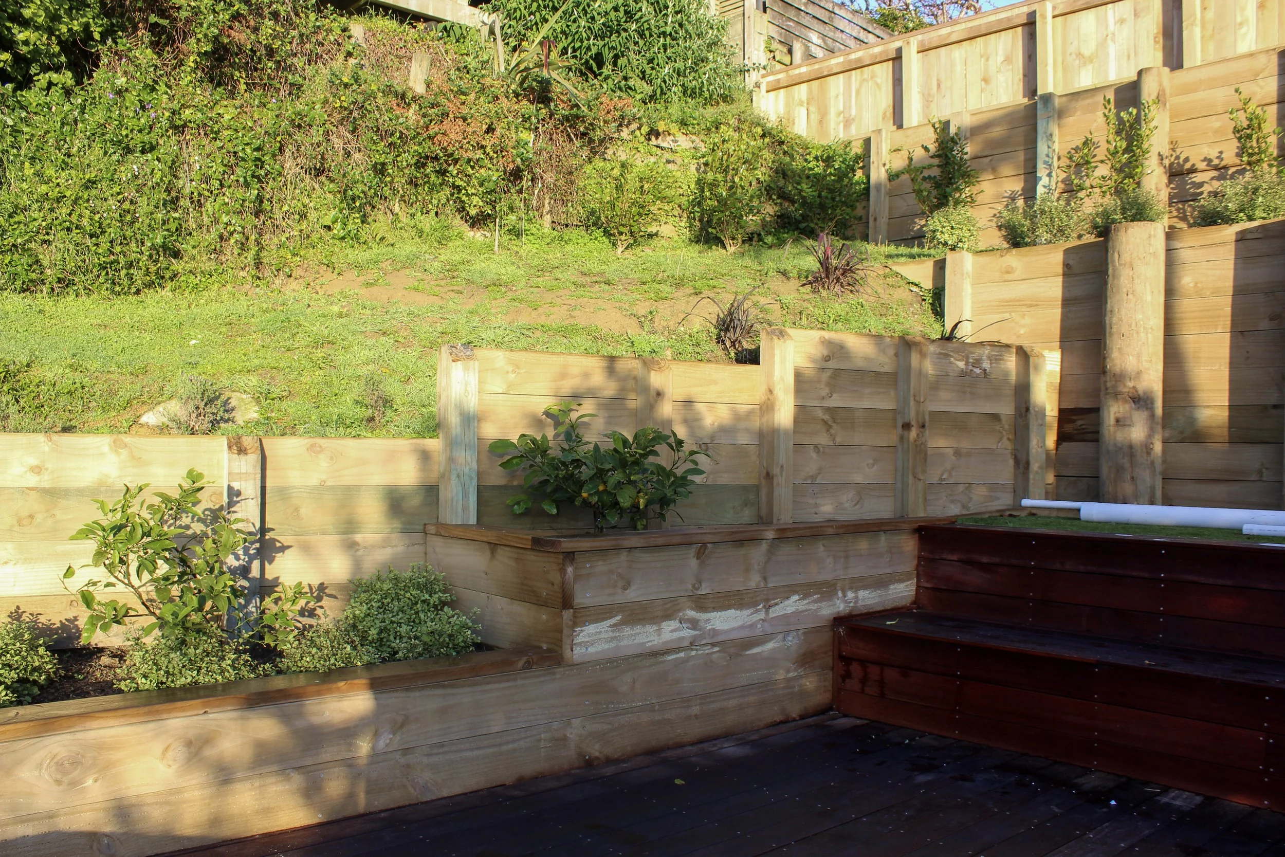 Step-down planter beds to increase the greenery within the space, or potential usability of the area.