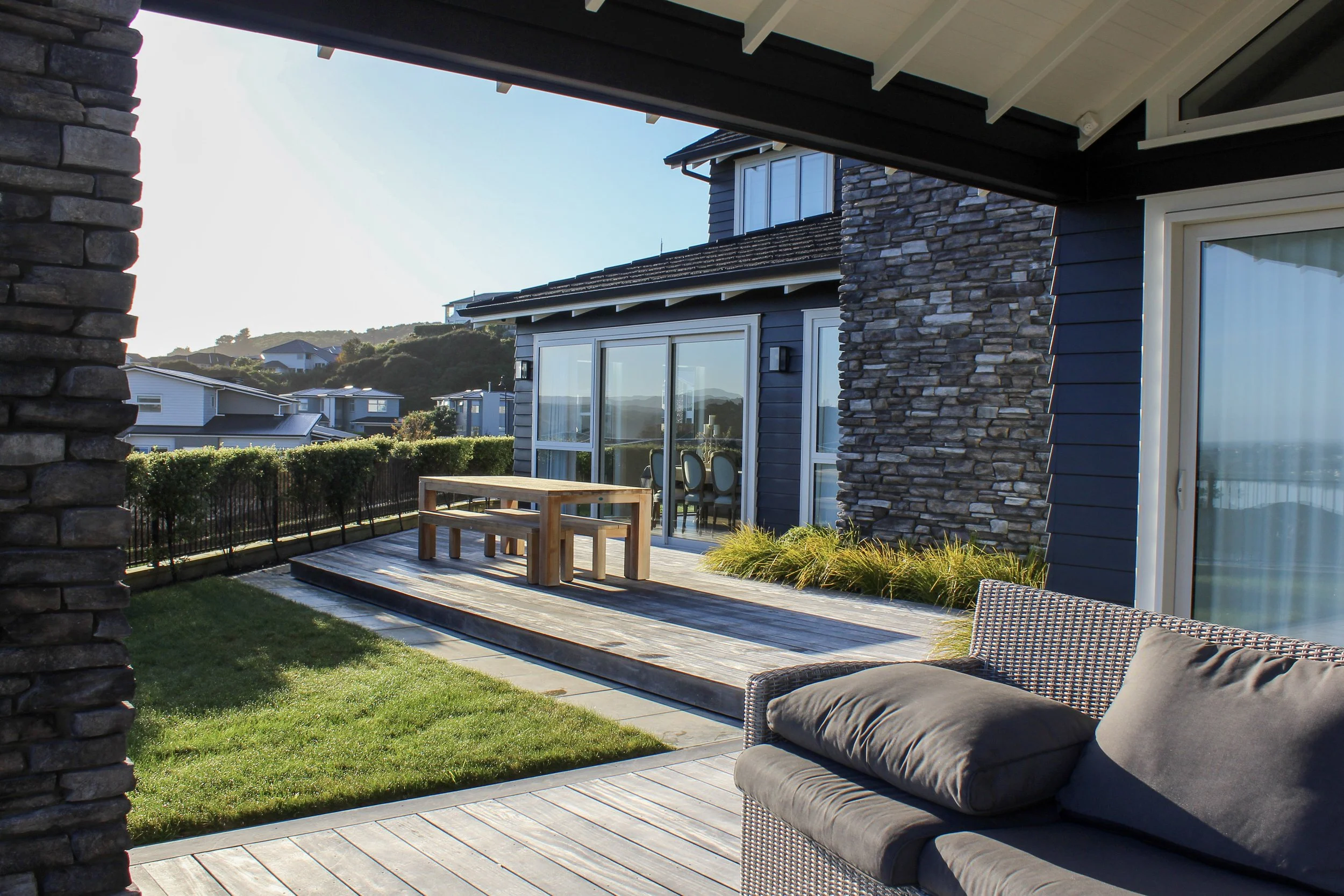 Soft flowing grass species work perfectly in the seasonally wind-stricken area to break up the hard materials.