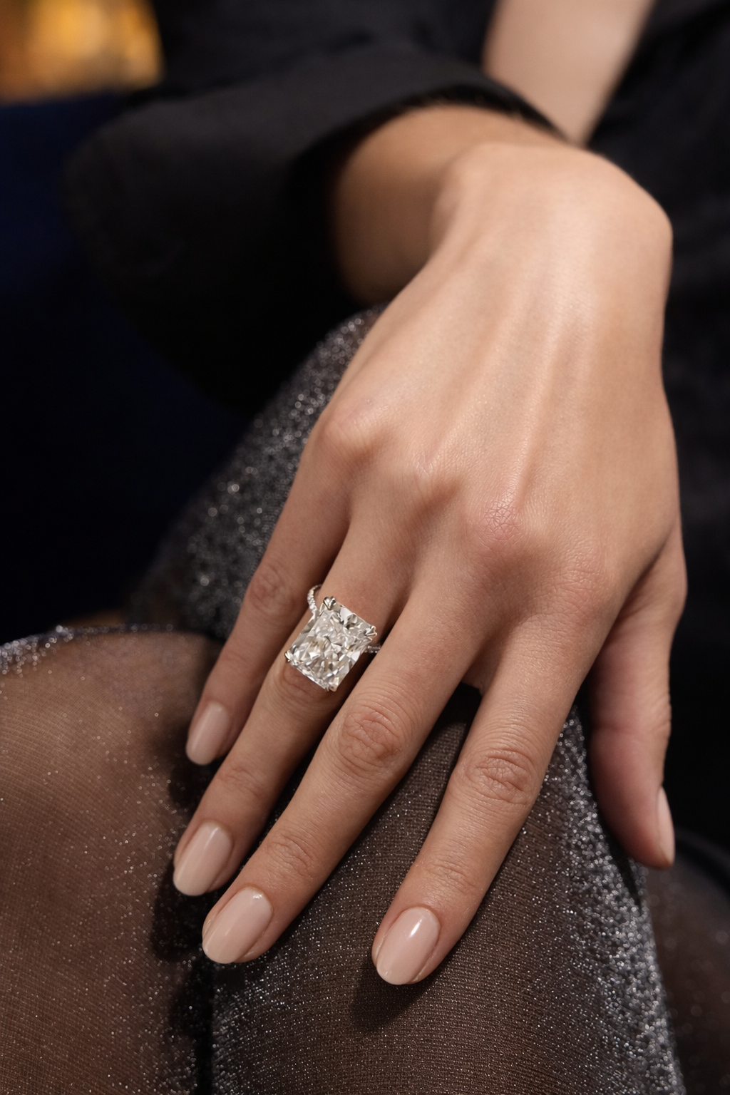 Close-up of a hand wearing a bespoke emerald-cut diamond ring by NICHÉ, crafted in Antwerp fine jewellery atelier.