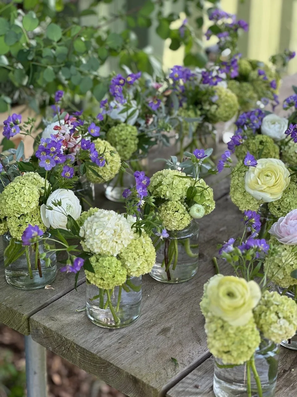 glass vases filled with flowers.jpeg