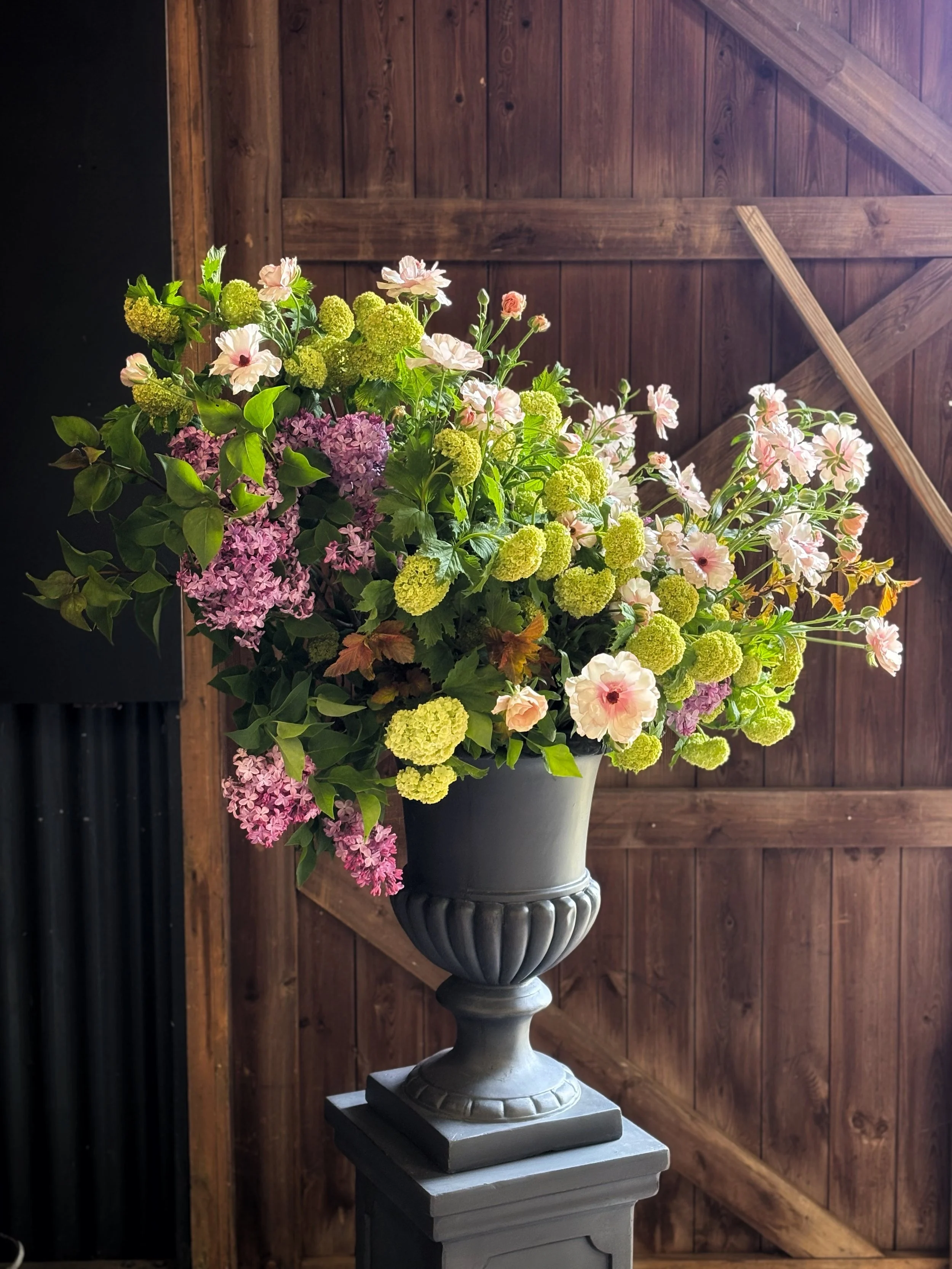Dark grey urn filled with Spring flowers from Chippy Flower Farm .jpeg