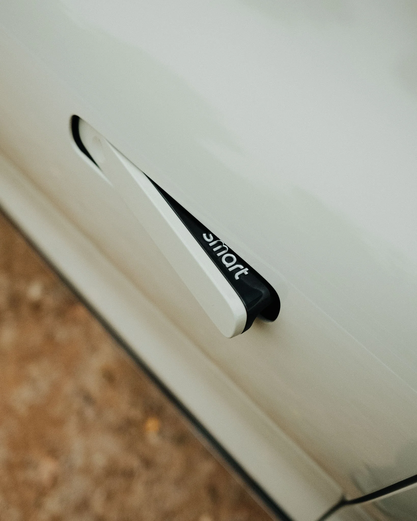 Close-up of a white dishwasher with the brand name 'shurt' partially visible.