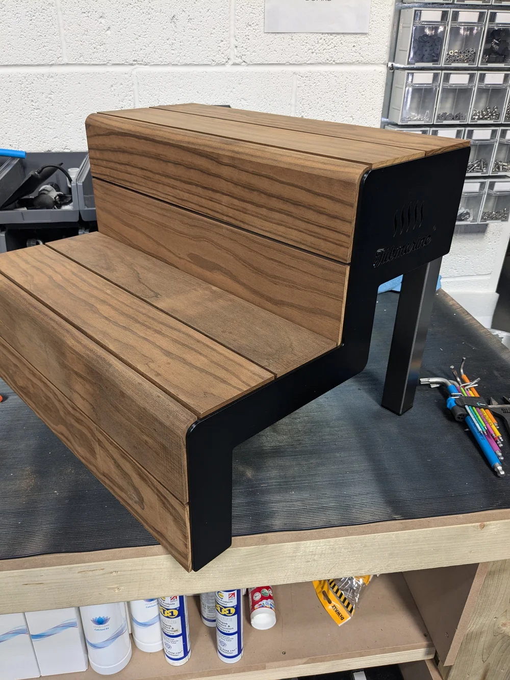 A finished timber and steel bench on the workbench.