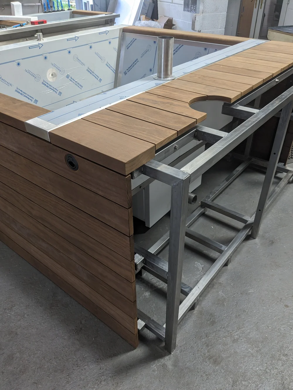A timber deck being shaped, with the opening cut for the tub.