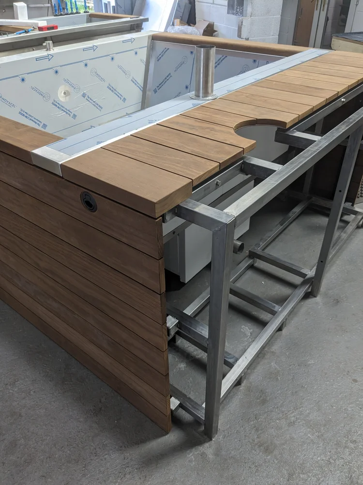 Kebony cladding and decking being fitted to the frame