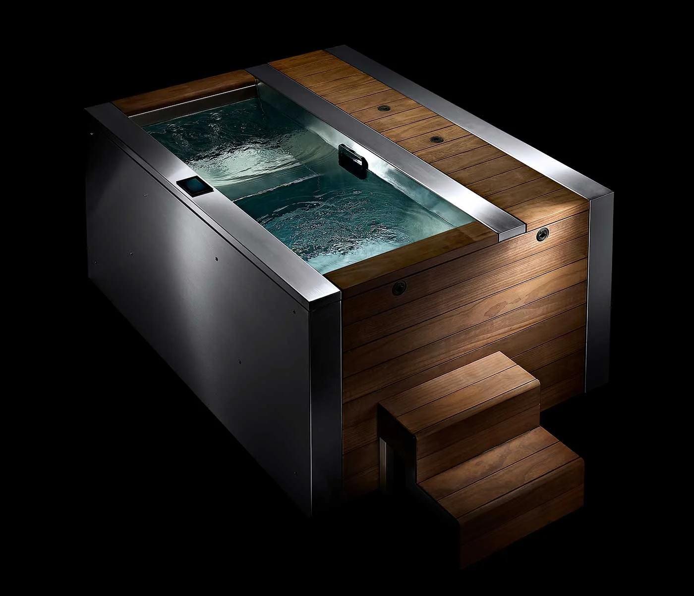 A Tubmarine hot tub with wood paneling, metal accents, and built-in steps, filled with water, against a black background.