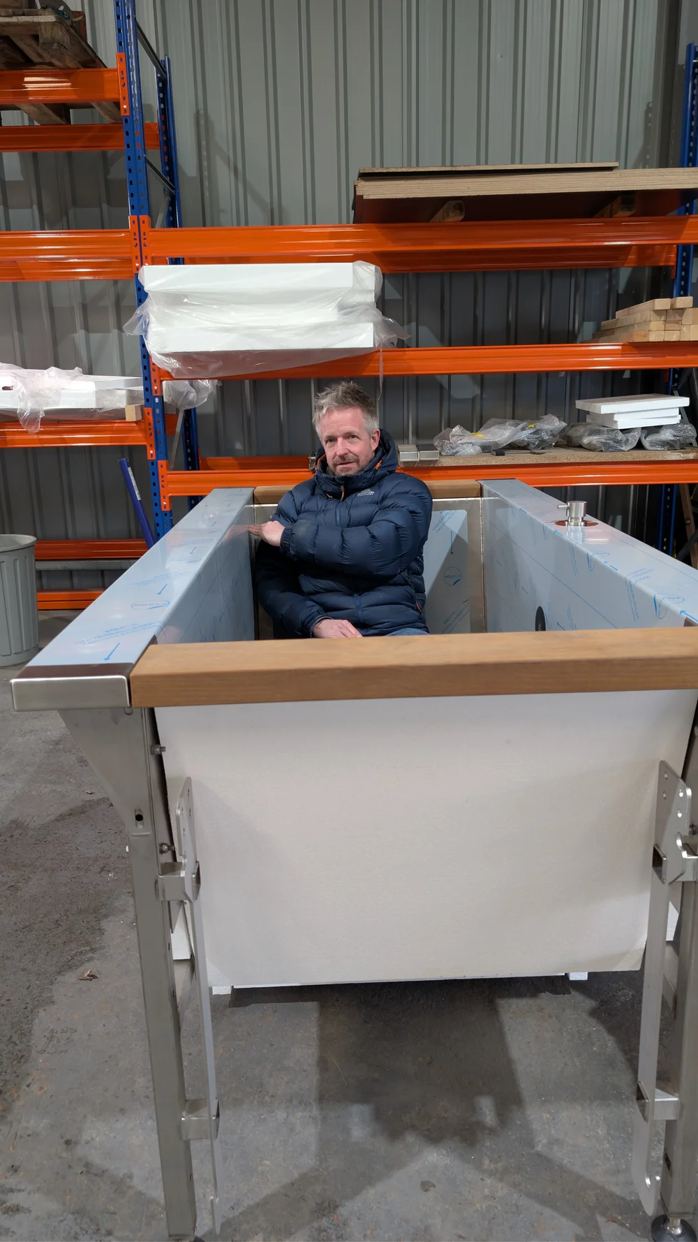 A finished tub interior, shown with a person seated inside for scale.