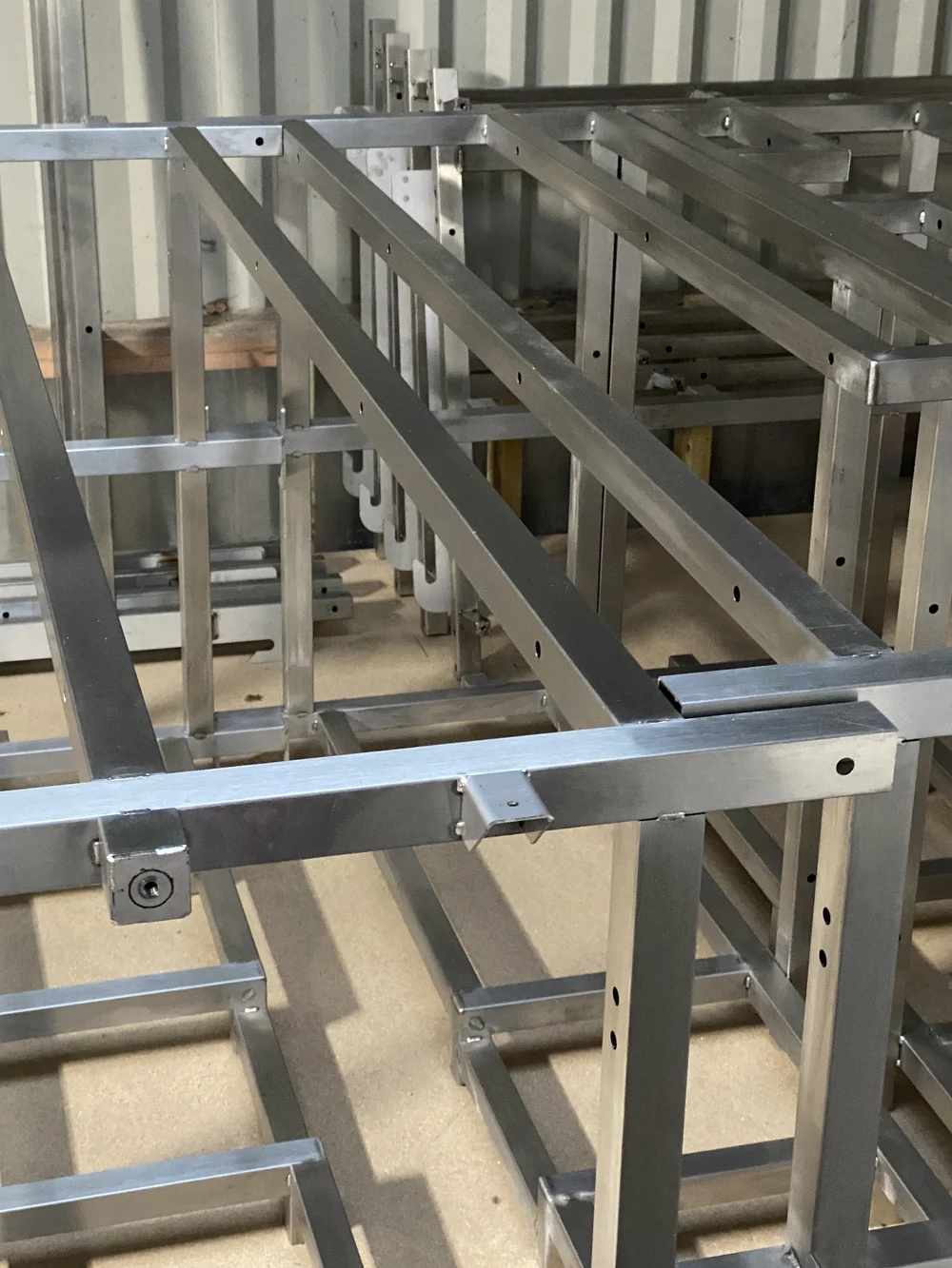 Stainless steel internal frames lined up in the workshop.