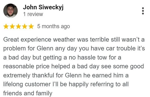 Screenshot of a five-star Google review by John S. praising a towing service for good customer service and reasonable pricing, despite bad weather and car trouble.