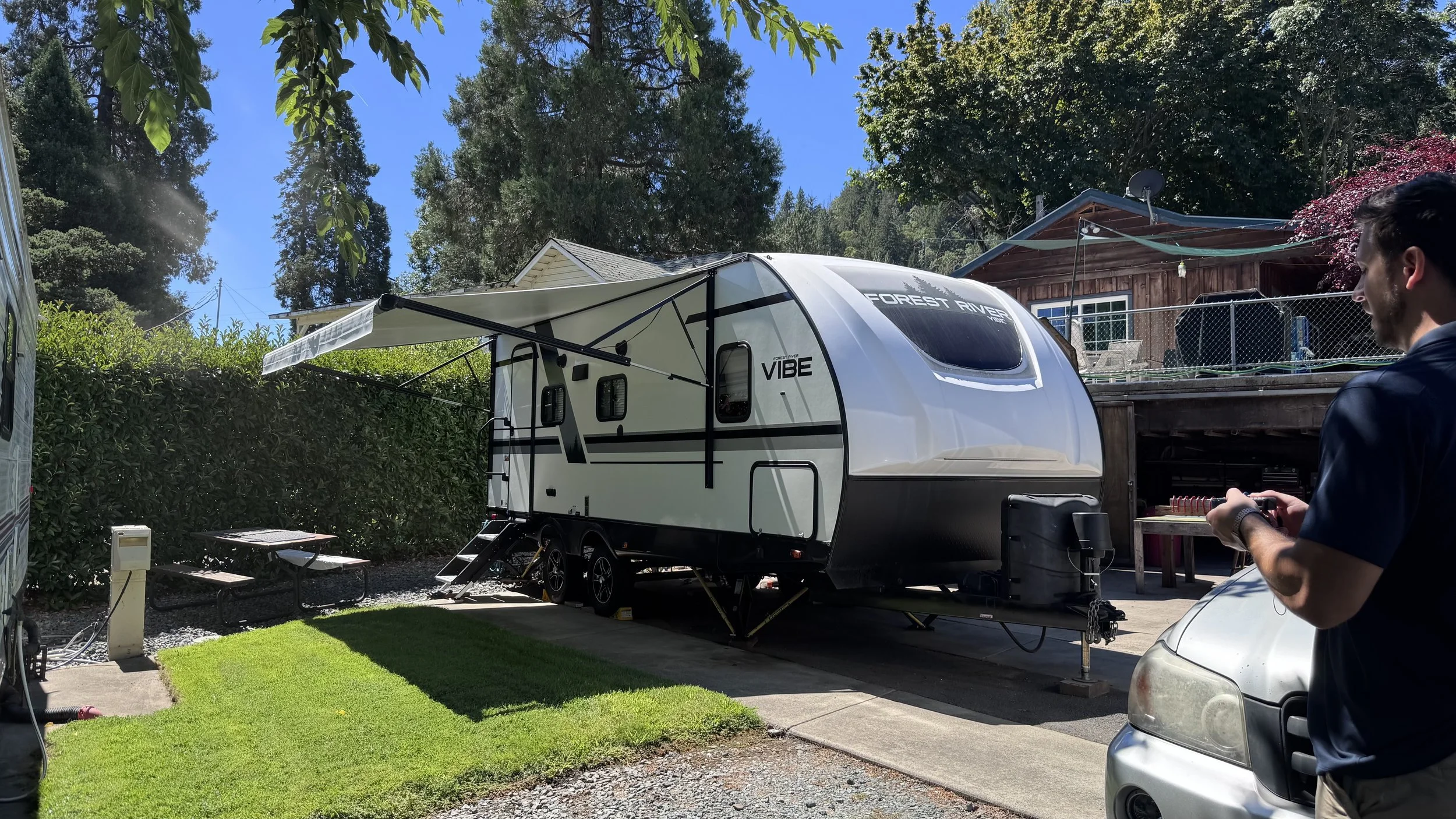 Back-in RV site with cement pad and grass