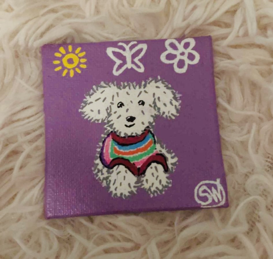 Cute stuffed animal dog in a rainbow sweater matching friendship magnet painting