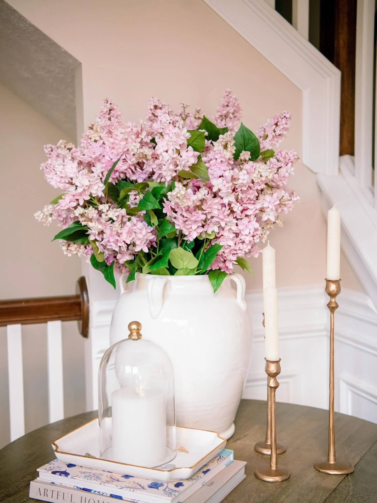 I helped a client spruce up her entryway table by adding a new much larger vase, faux florals to help give this table a focal point. The rest of the accessories we just shopped her house since she already had great stuff! 🥰

I am so ready for spring