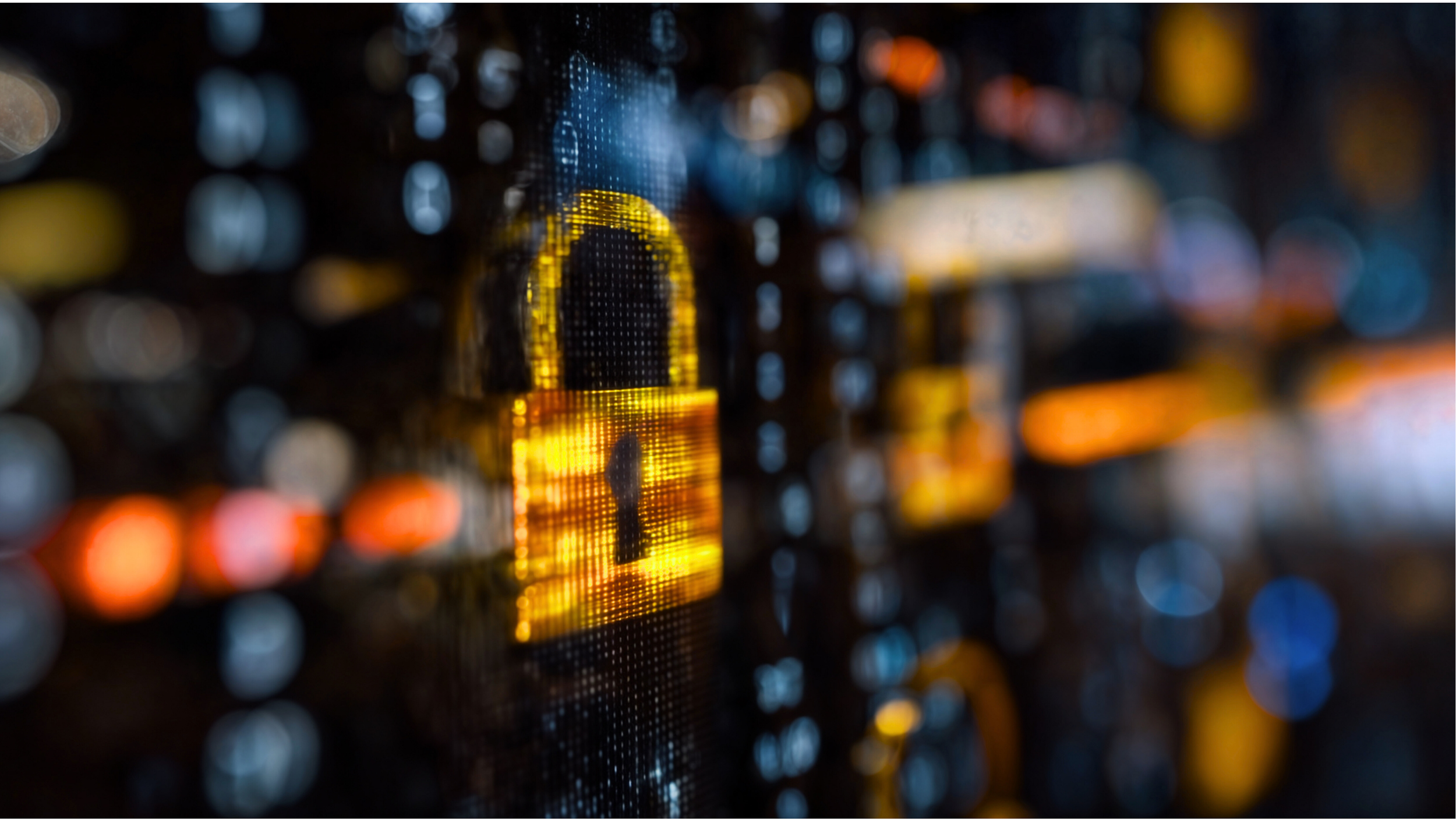 Close-up of a digital lock icon glowing yellow on a computer screen with blurred multicolored background lights.