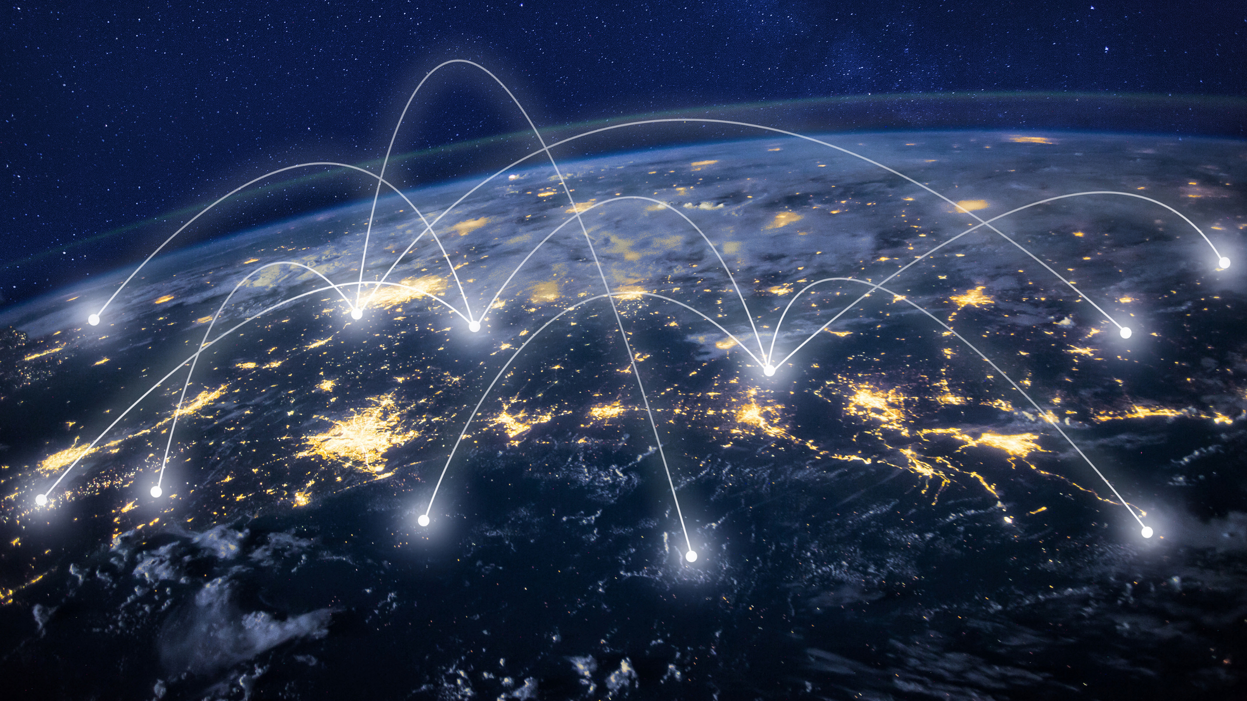 Earth from space with illuminated cities and connecting white lines indicating global communication or data transfer.