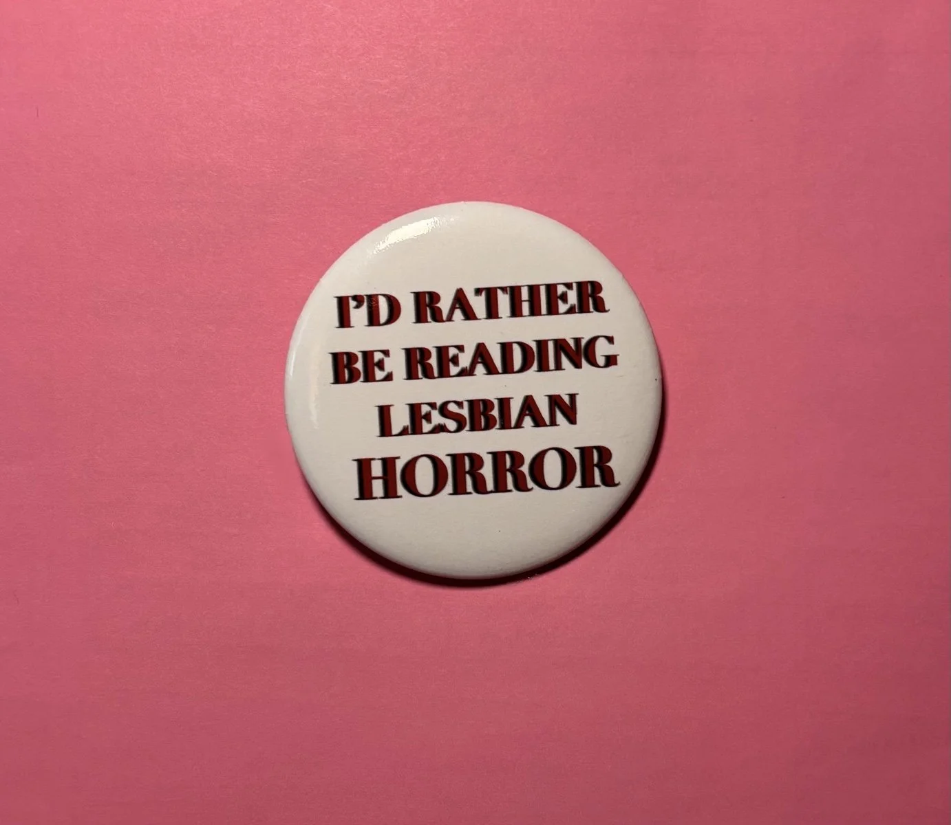 lesbian horror; horror books; I'd rather be reading lesbian horror; I'd rather be reading lesbian things button pin; horror movies; Nomad Nirvana Books; merch