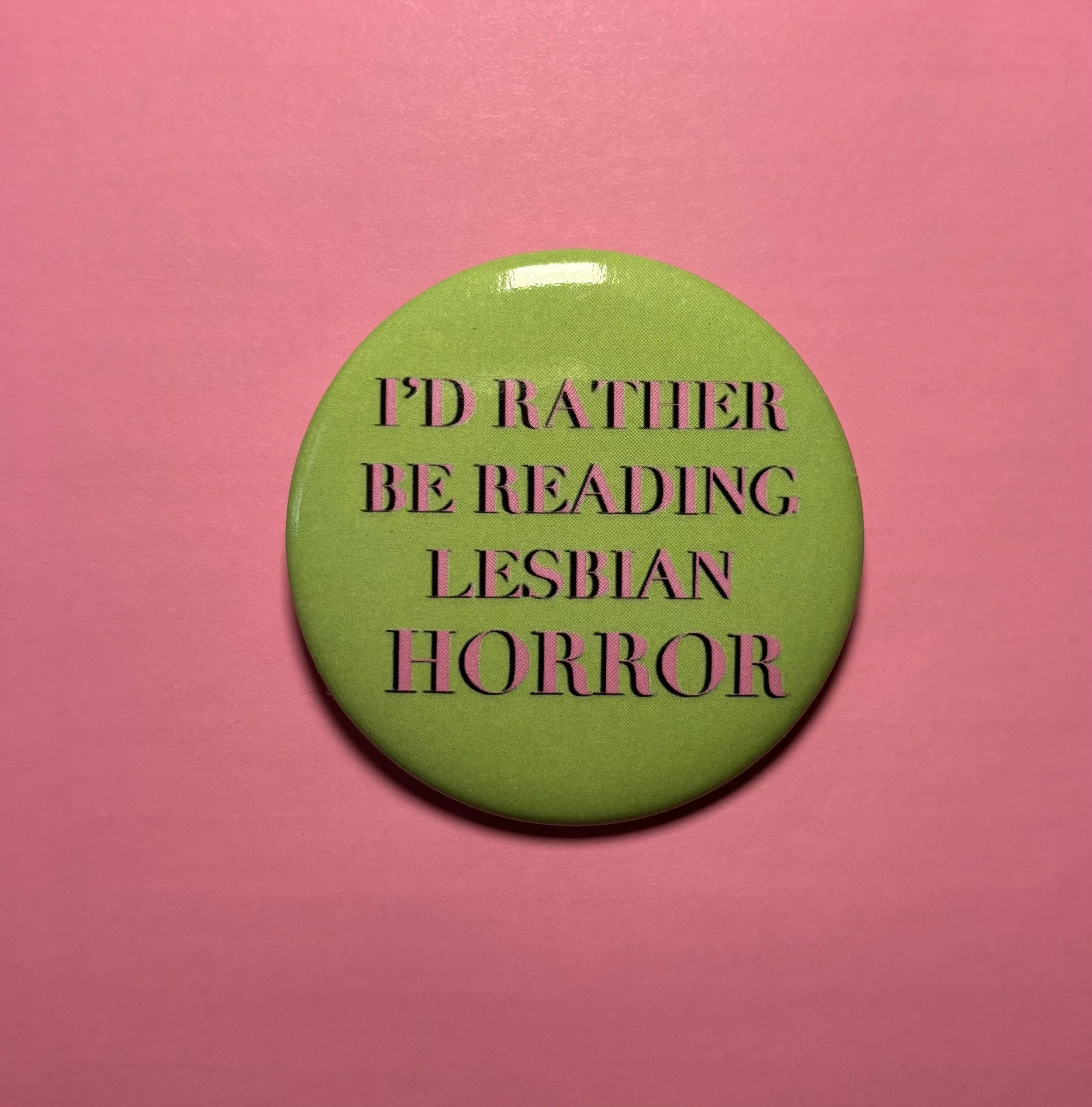 lesbian horror; horror books; I'd rather be reading lesbian horror; I'd rather be reading lesbian things button pin; horror movies; Nomad Nirvana Books; merch