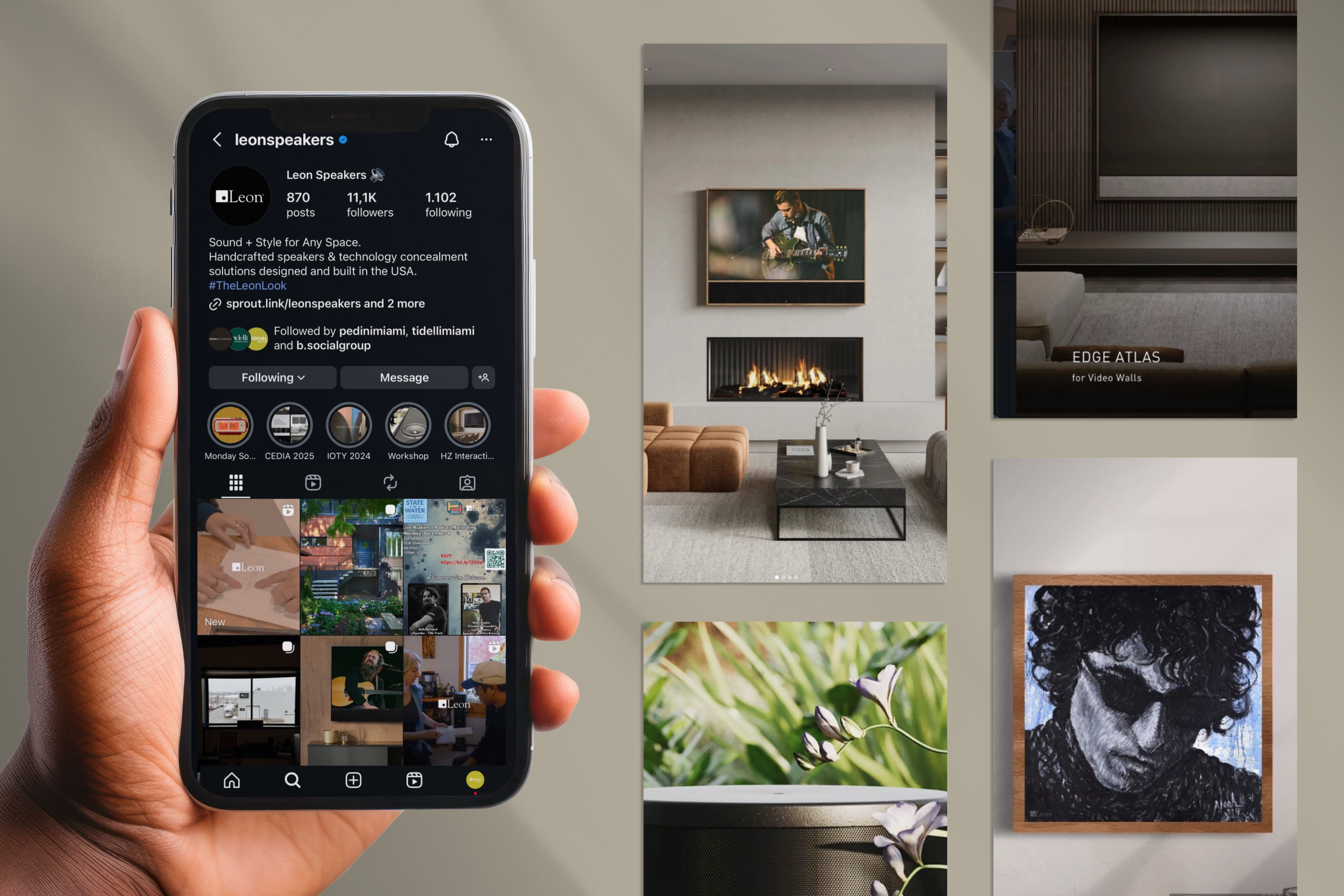 Hand holding smartphone showing an Instagram profile for 'leonspeakers,' a modern living room with artwork, a fireplace, and a TV, and a wall decor with a black and white portrait of a young man with curly hair and sunglasses.