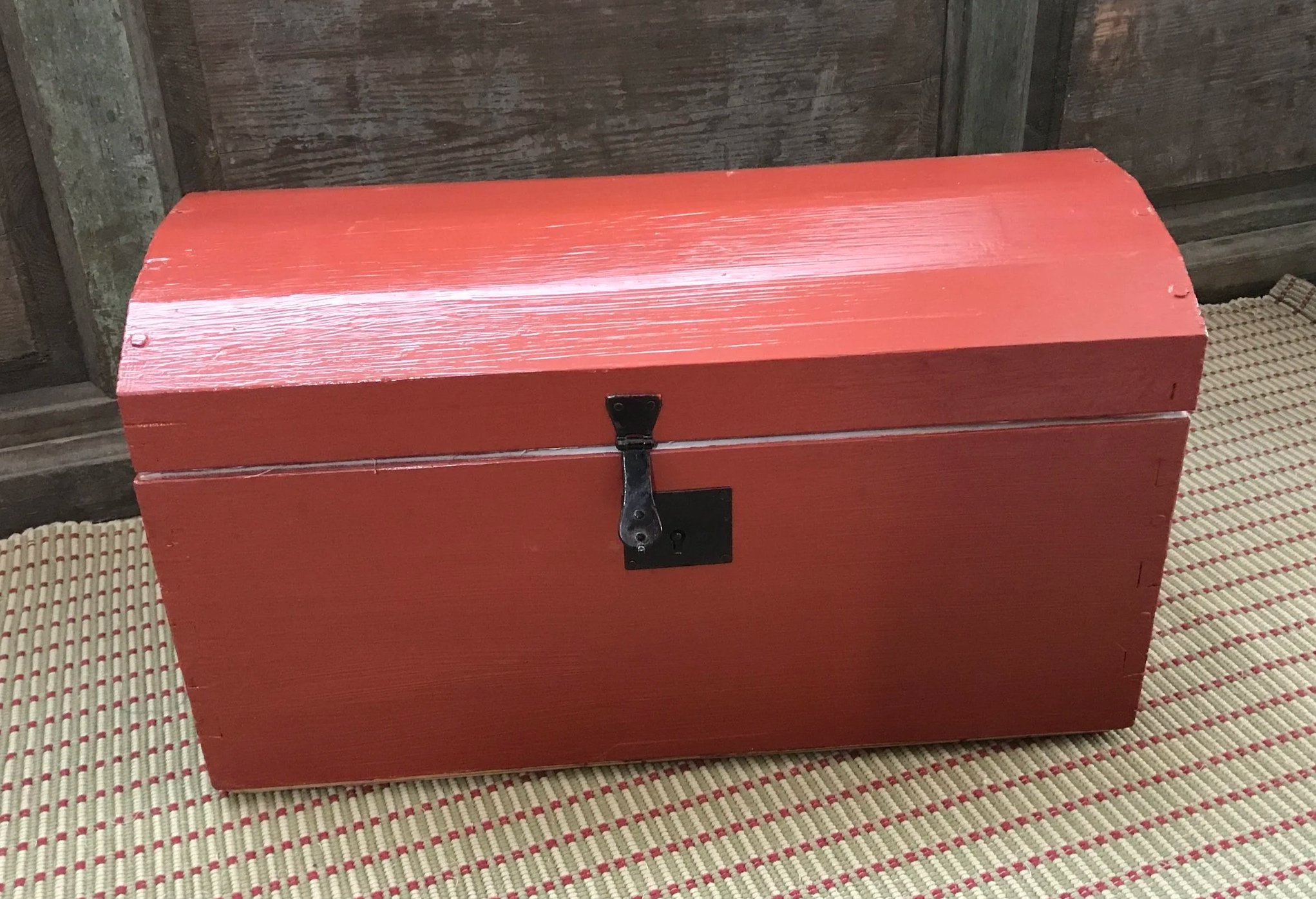 Red paint on naked wood is not as waterproof or as durable as using canvas, but does have its uses.