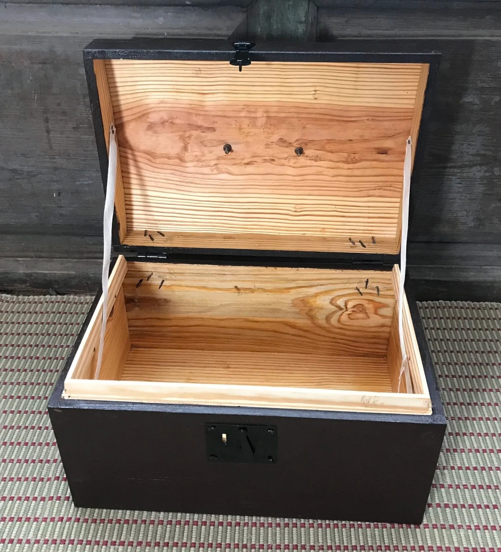 Unlined, as is the original. Note the nails clenched on the inside of the hinges.