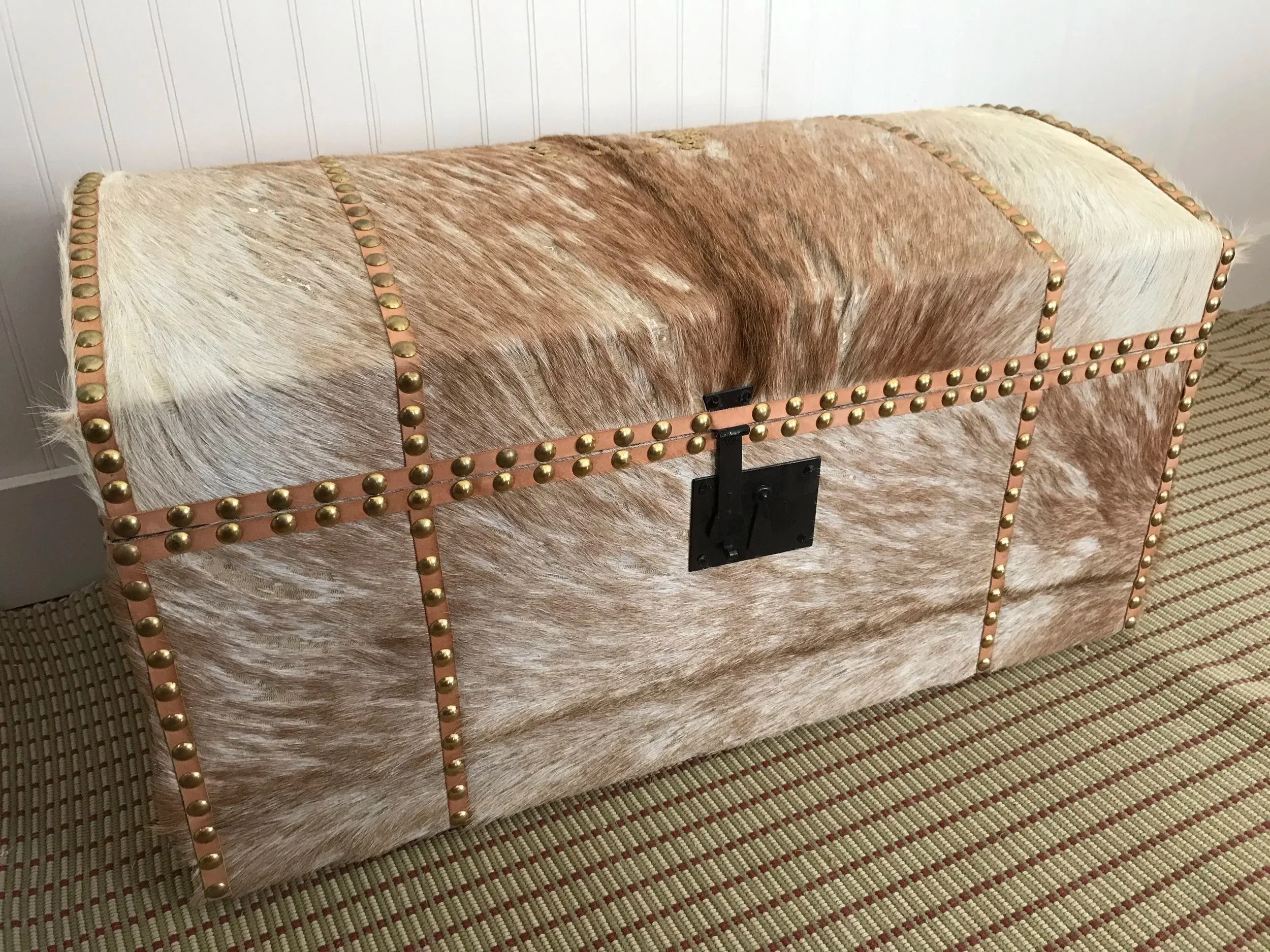 A large trunk (28" long) covered in raw goat hide. 