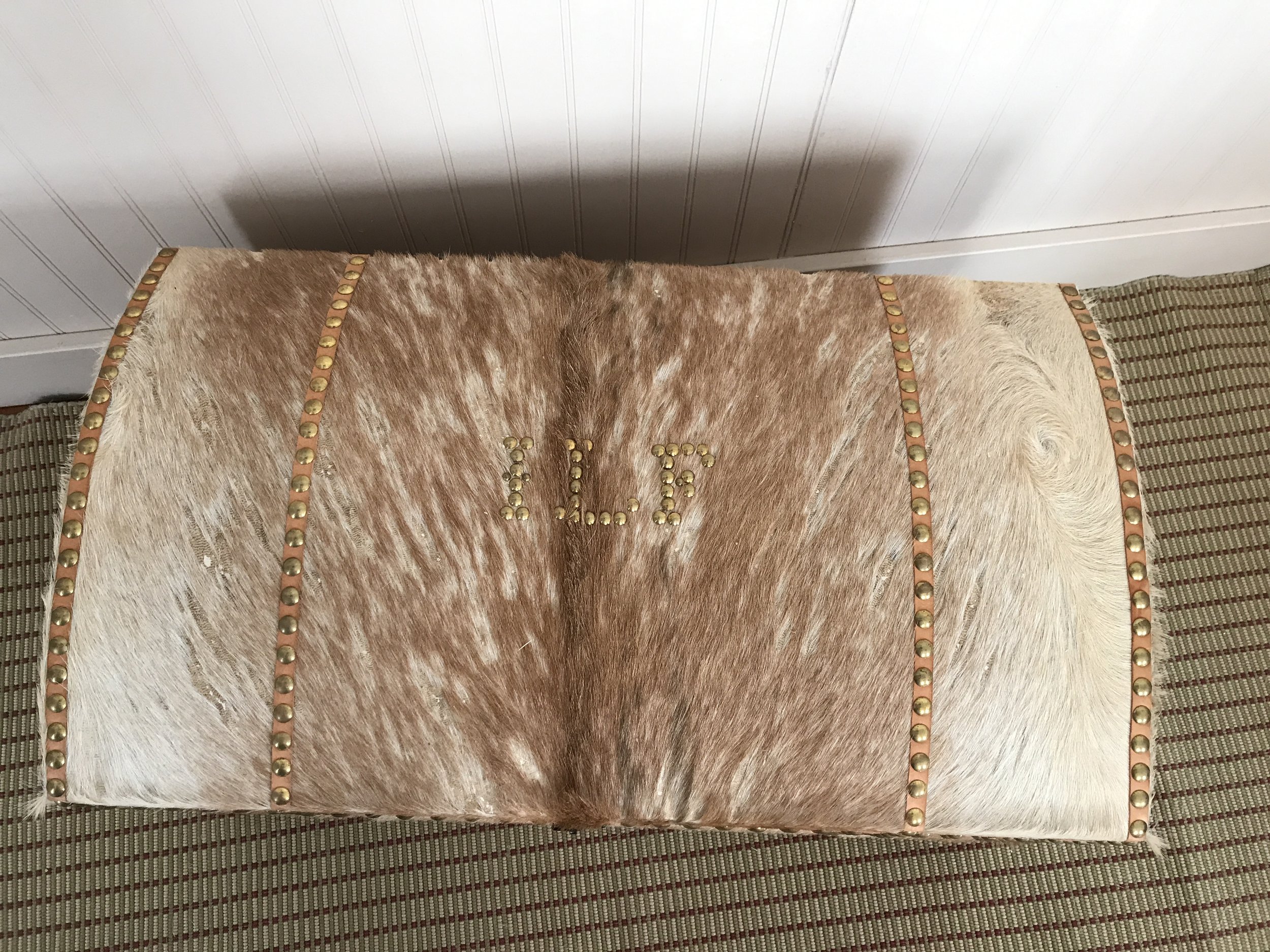 The owner's initials serve as a "luggage tag." Moth damage is evident; surviving trunks of hair-on hide rarely retain much hair due to moths and wear. They are still very water resistant.